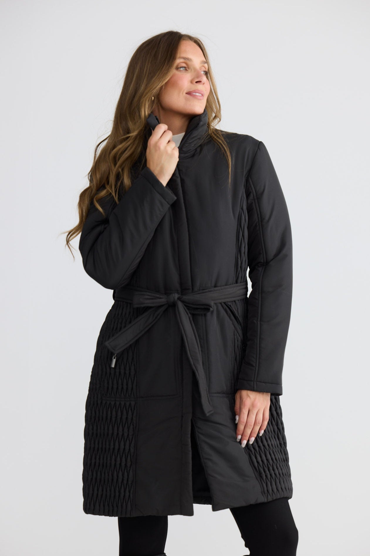 Model wearing Delphine Puffer black puffer jacket with quilted panel detail, collared neckline, front view on white background