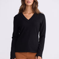 Model wearing Cassian LS Knit Top - Black, alternate studio view on white background