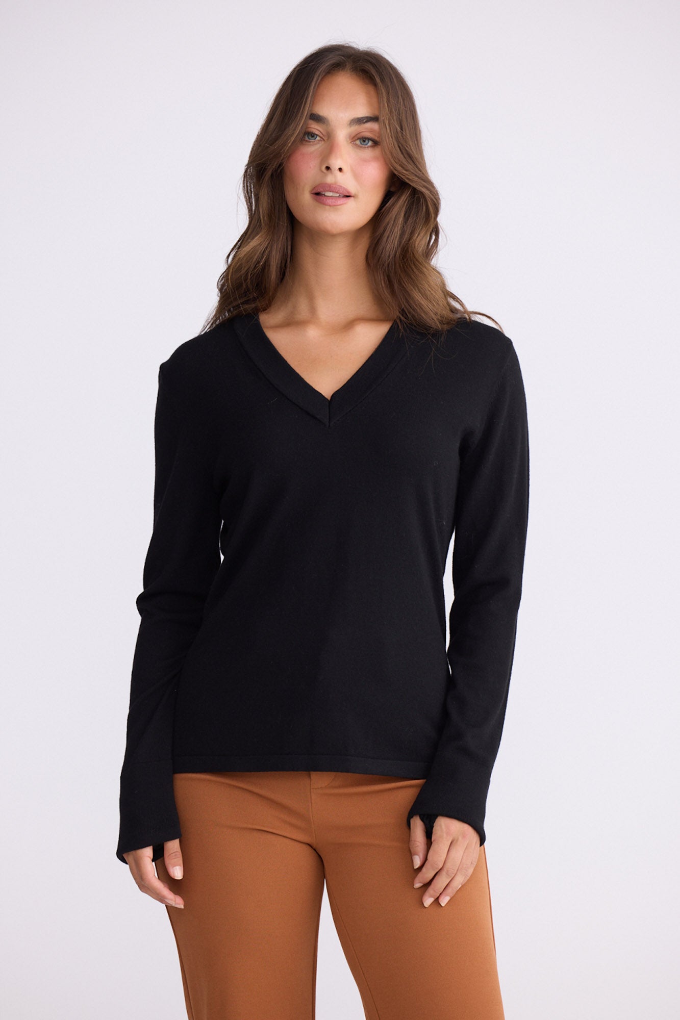 Model wearing Cassian LS Knit Top - Black, alternate studio view on white background
