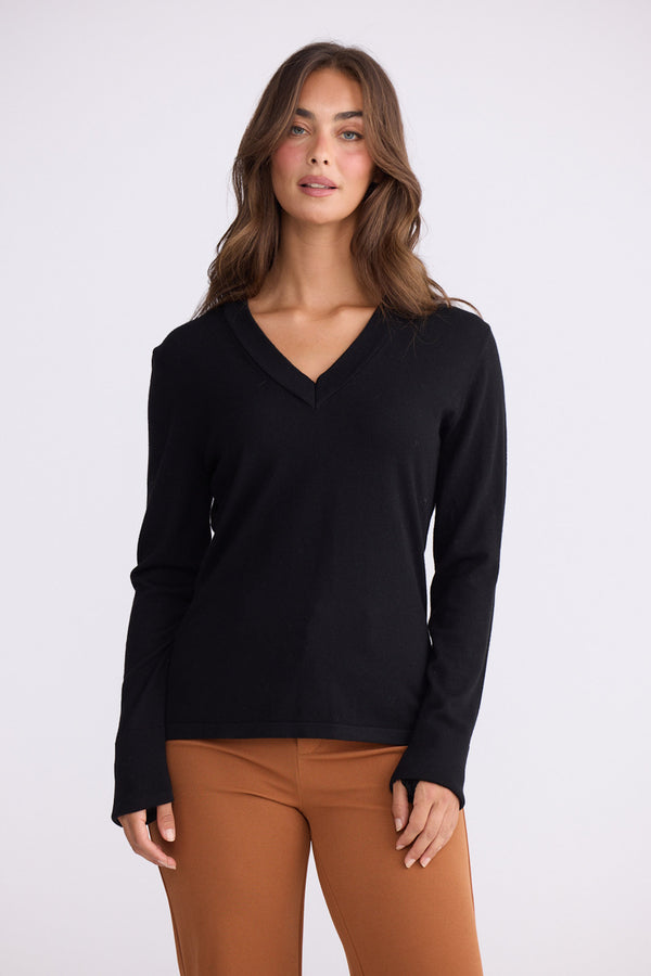 Model wearing Cassian LS Knit Top - Black, alternate studio view on white background