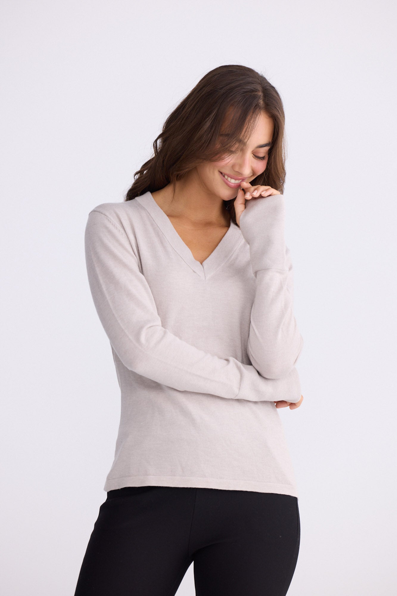 Model wearing Cassian LS Knit Top - Dove, studio view on white background