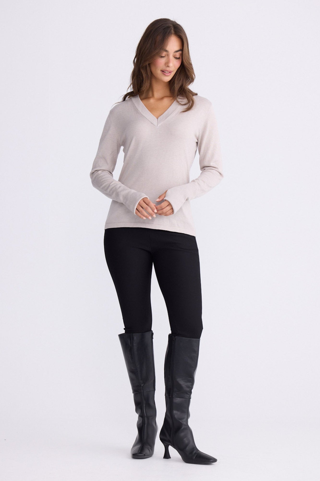 Model wearing Cassian LS Knit Top - Dove, alternate studio view on white background