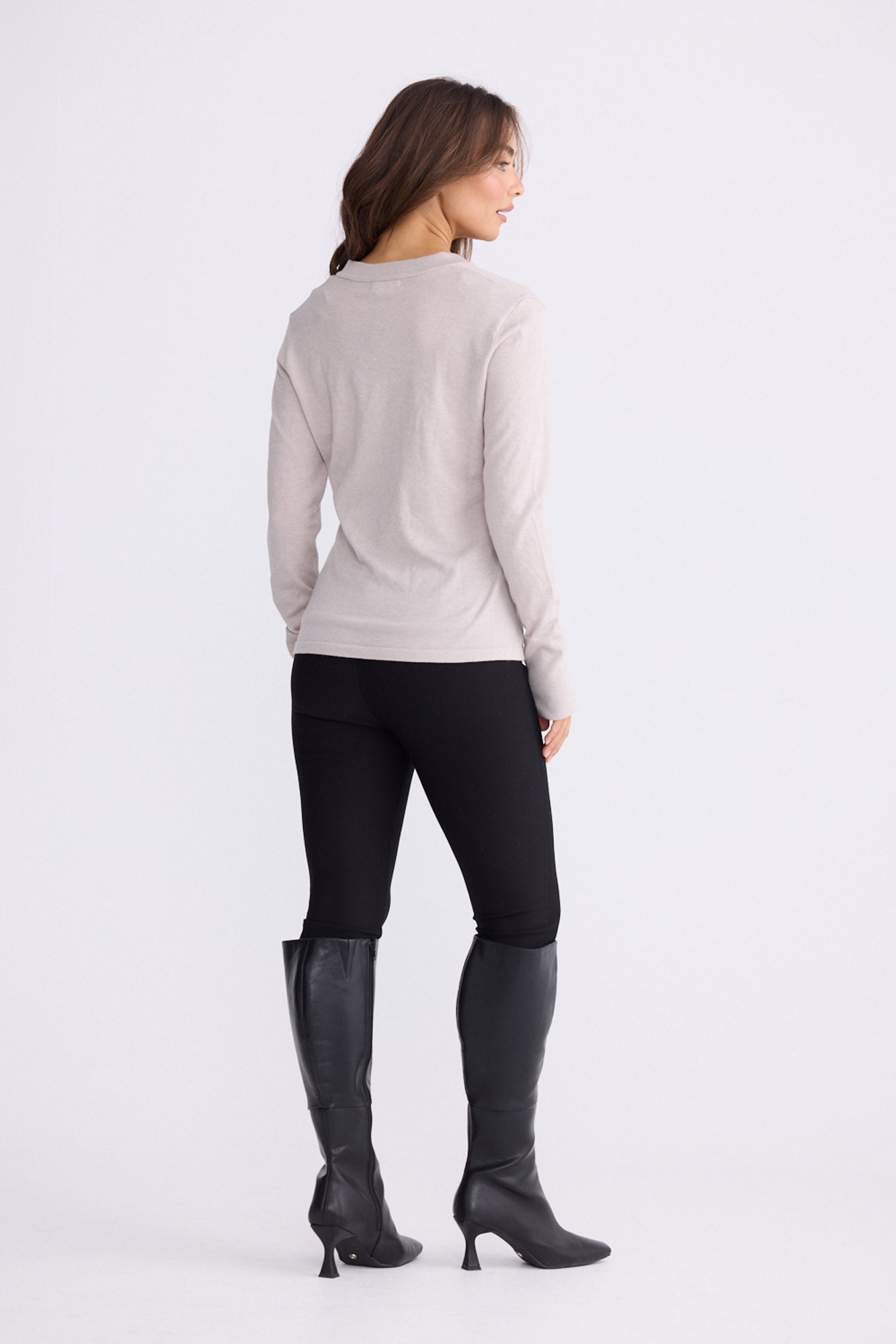 Model wearing Cassian LS Knit Top - Dove, alternate studio view on white background