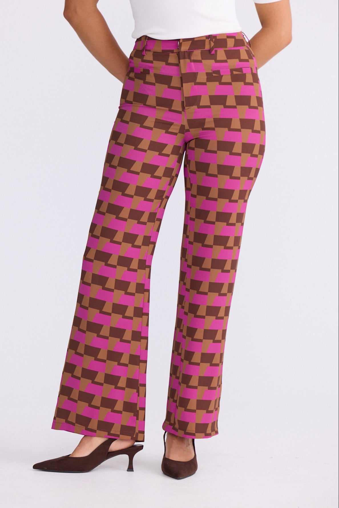 Model wearing Tressa Geo Prism geometric flared pants with high-rise waist, close-up front view on white background
