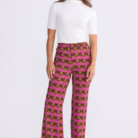 Model wearing Tressa Geo Prism geometric flared pants with high-rise waist, alternate view on white background