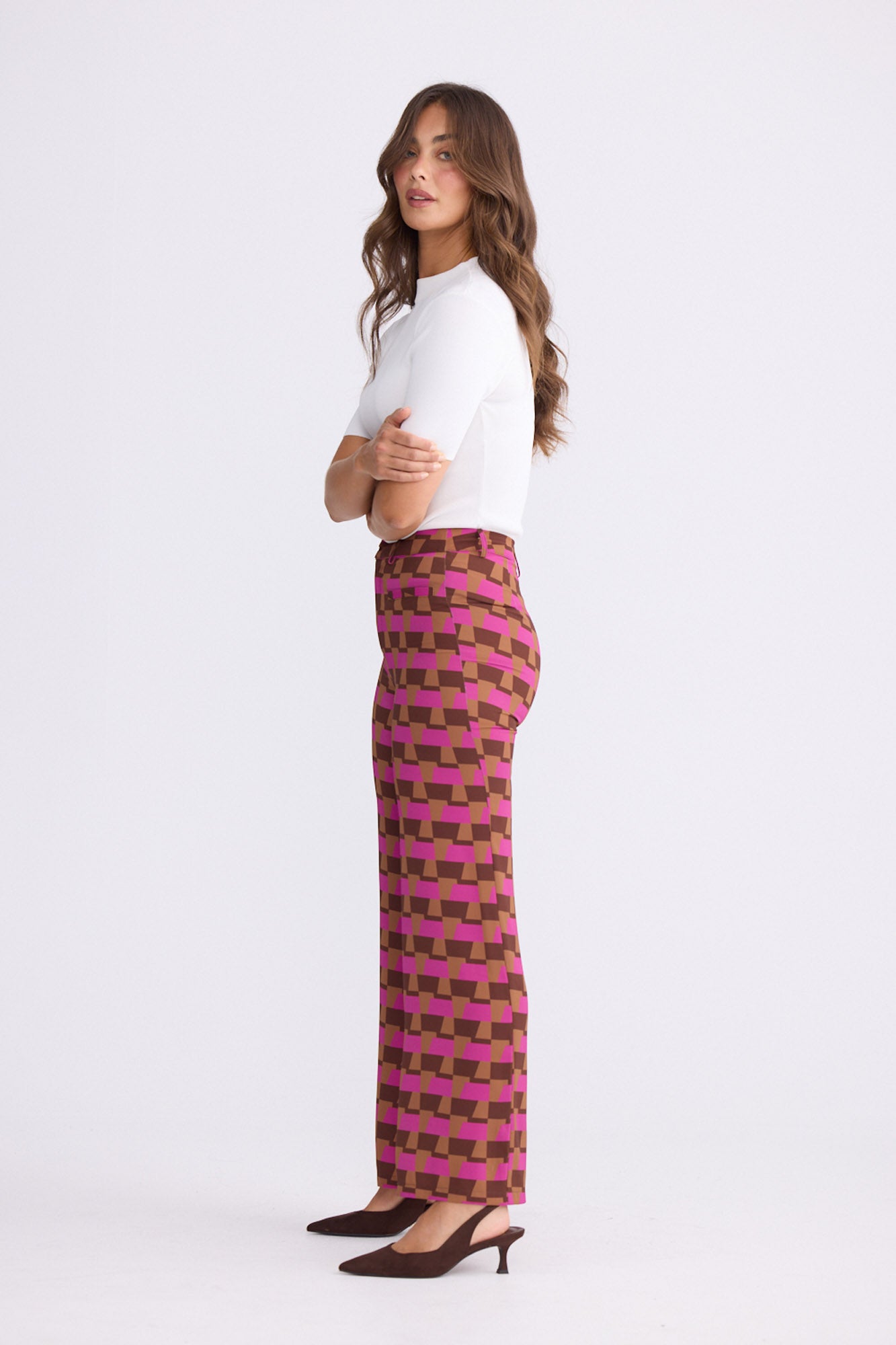 Model wearing Tressa Geo Prism geometric flared pants with high-rise waist, alternate view on white background
