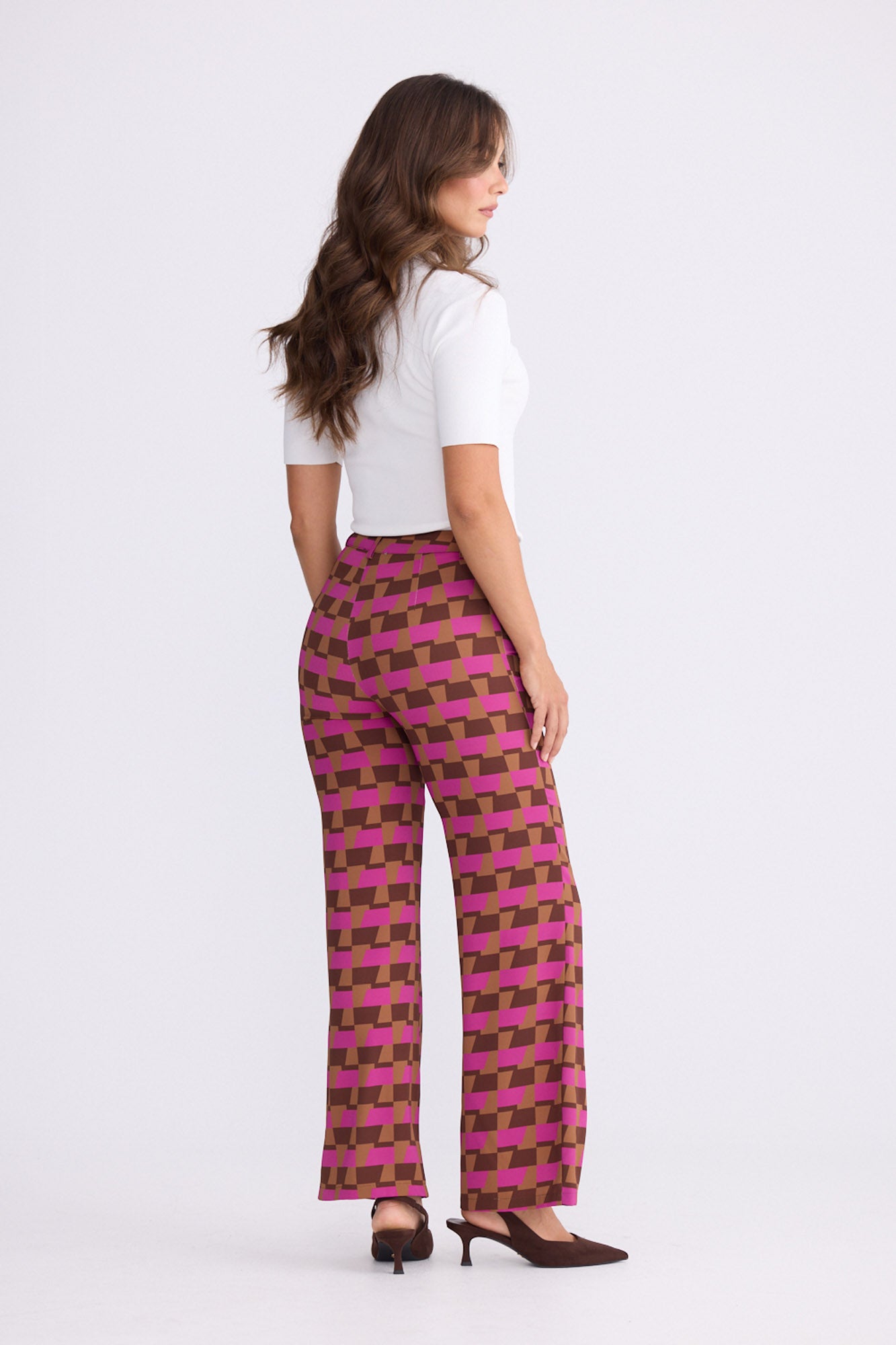 Model wearing Tressa Geo Prism geometric flared pants with high-rise waist, alternate view on white background