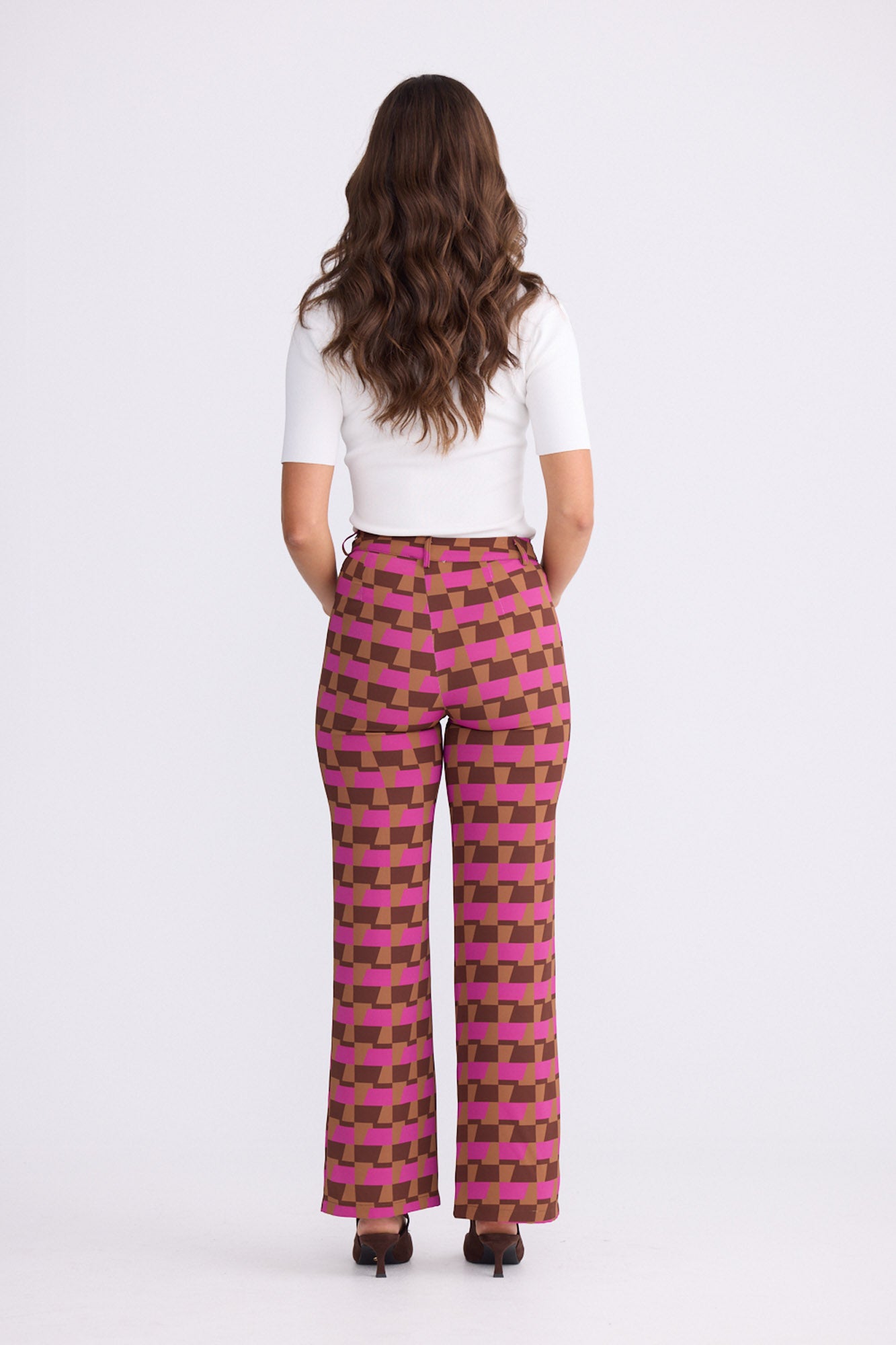 Model wearing Tressa Geo Prism geometric flared pants with high-rise waist, alternate view on white background