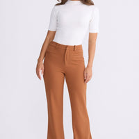 Model wearing Tressa pecan flared pants with high-rise waist, alternate view on white background