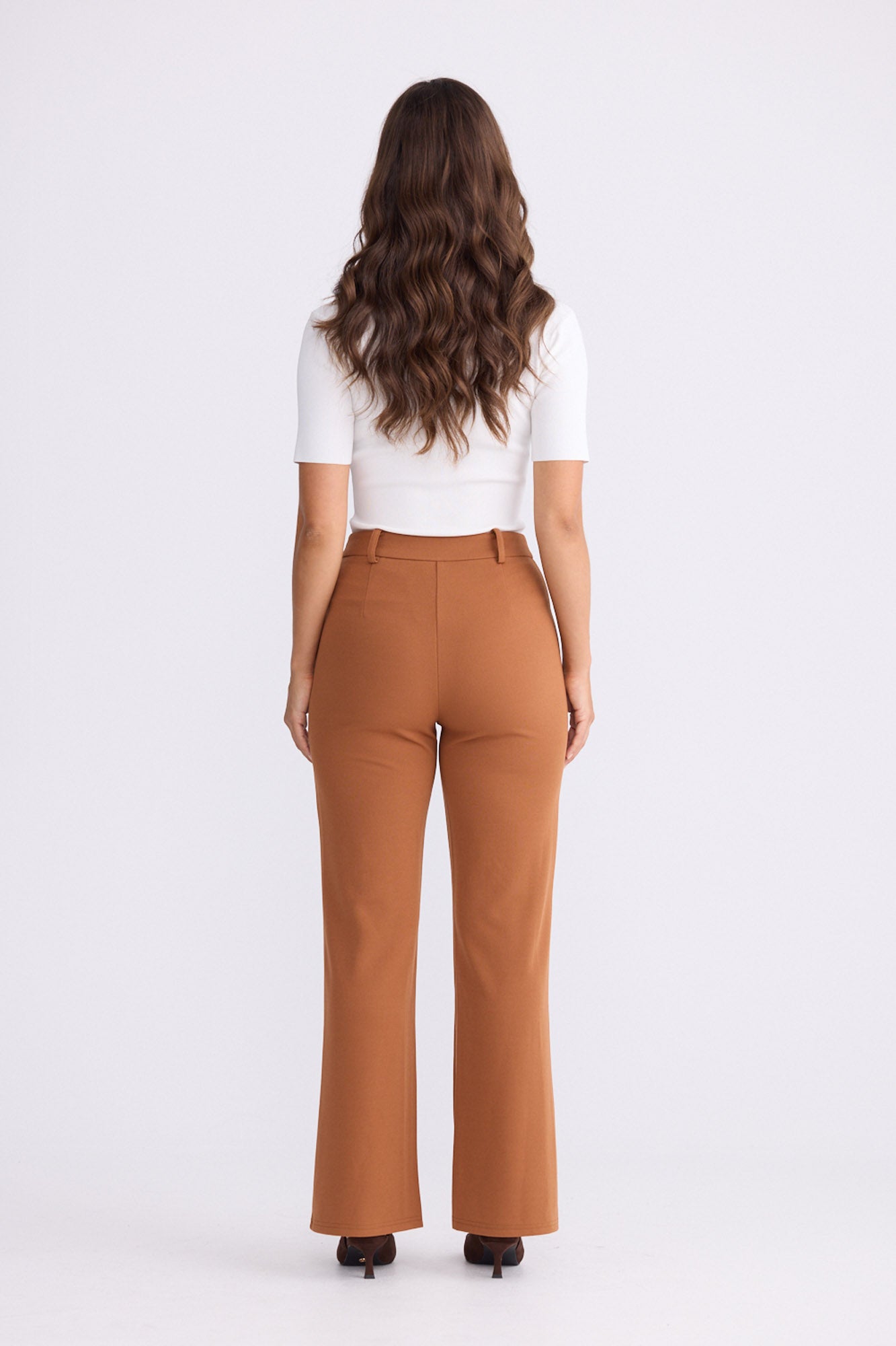 Model wearing Tressa pecan flared pants with high-rise waist, alternate view on white background