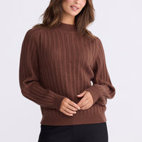 Model wearing Shea Knit in brown with crew neckline and long sleeves, front view on white background