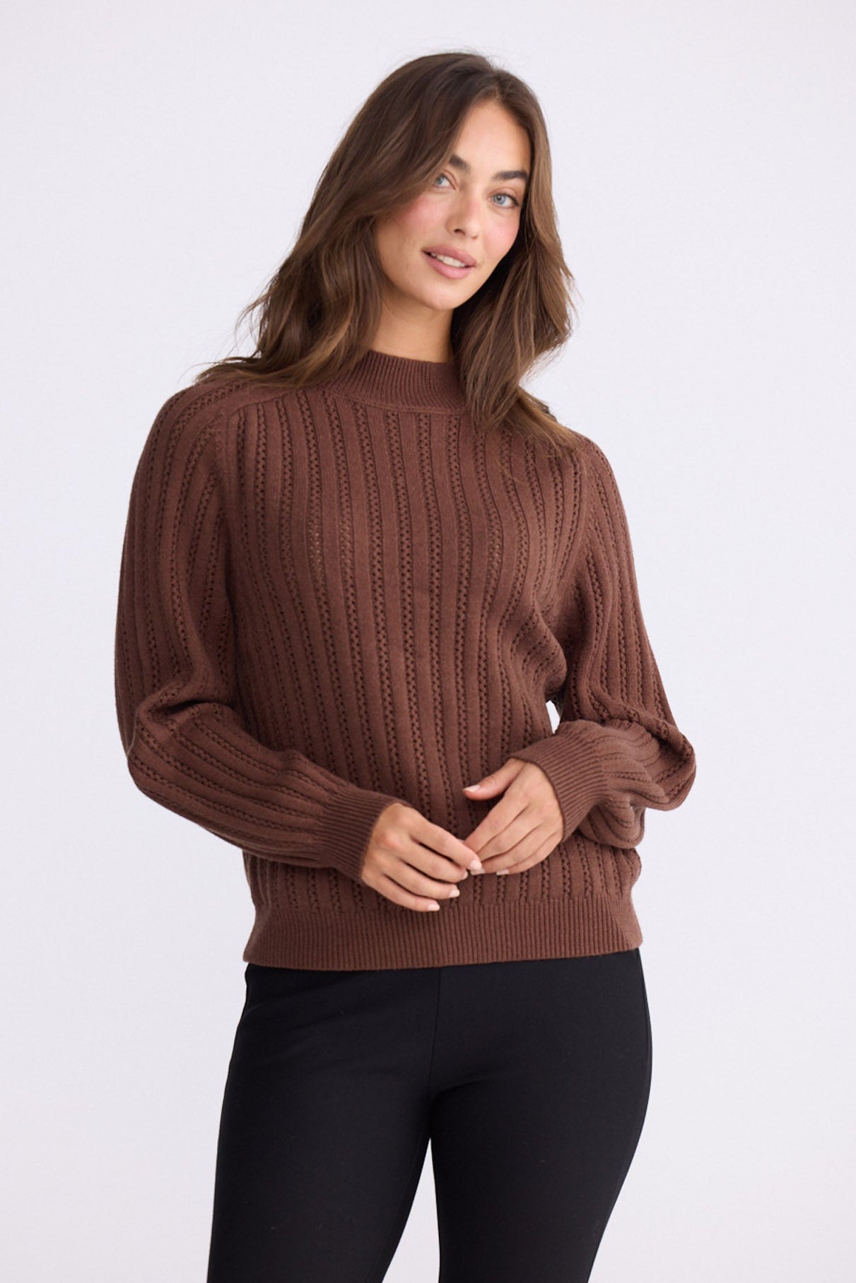 Model wearing Shea Knit in brown with crew neckline and long sleeves, front view on white background