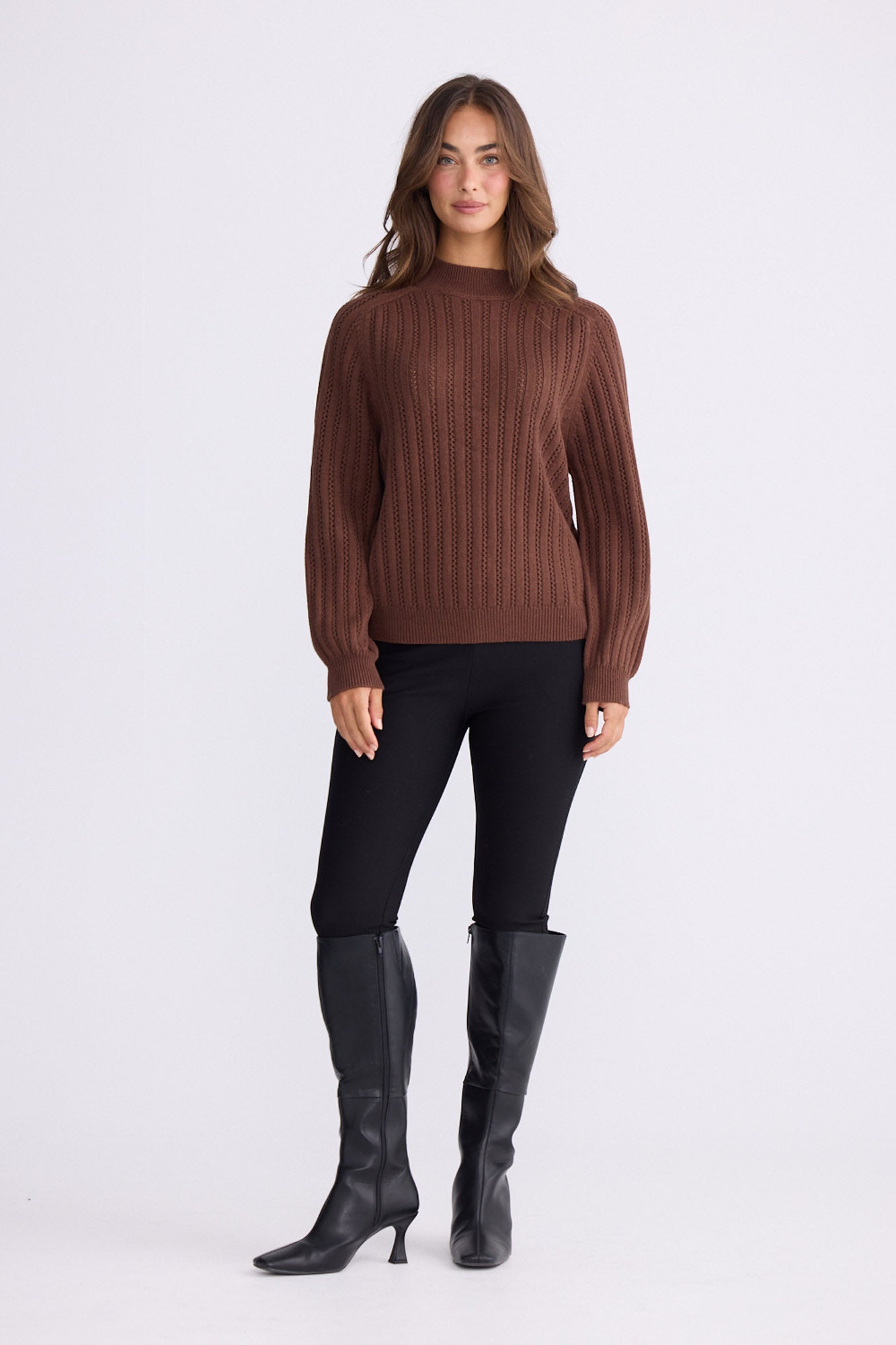 Model wearing Shea Knit in brown with crew neckline and long sleeves, front view on white background