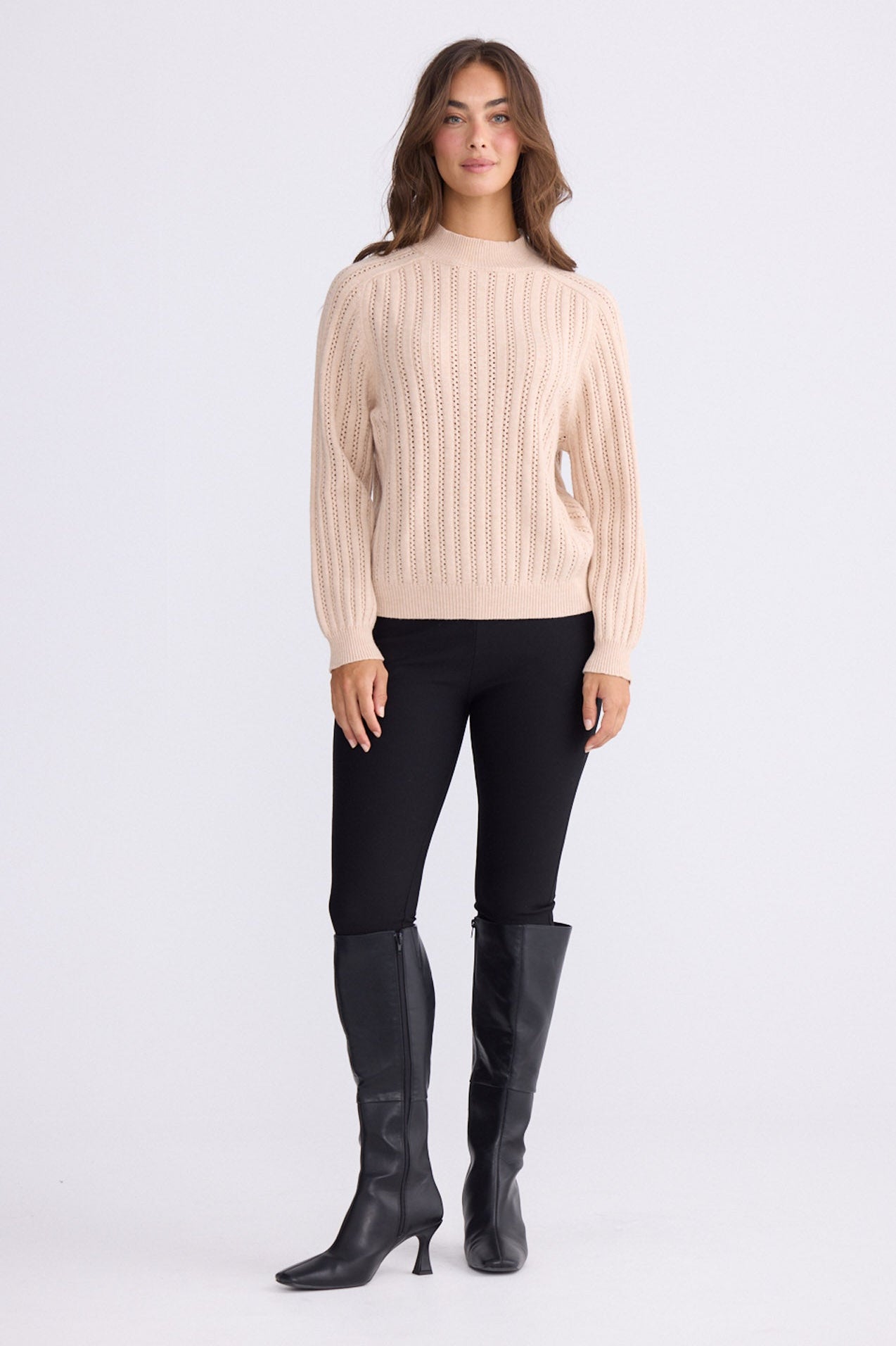 Model wearing Shea Knit in beige with textured knit, front view on white background