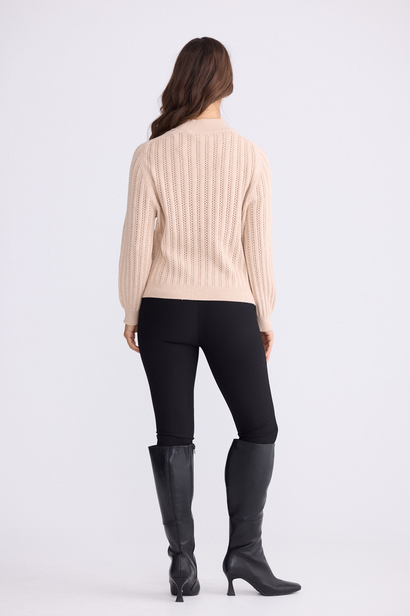 Model wearing Shea Knit in beige with textured knit, front view on white background