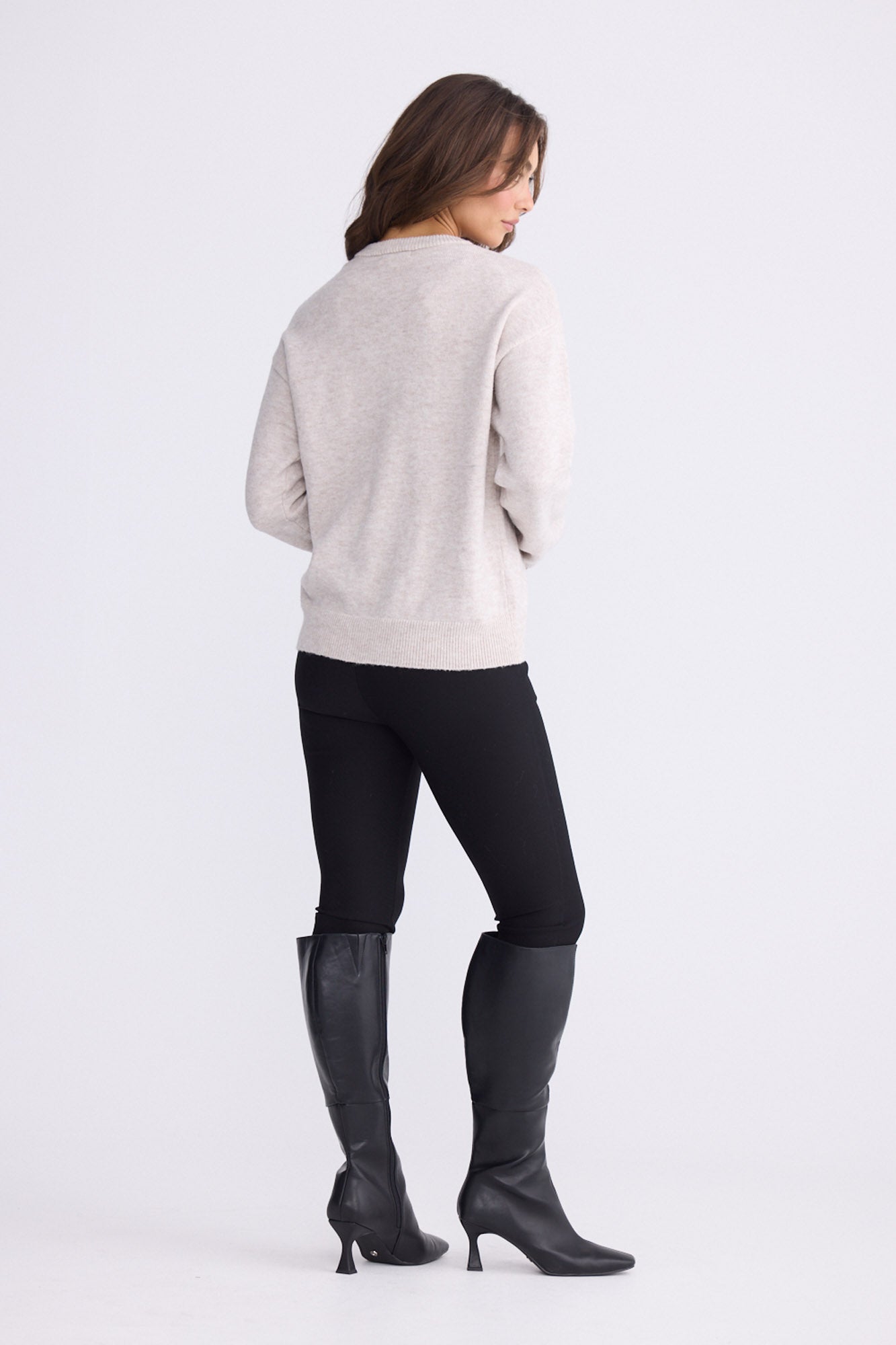Model wearing Casey Knit - Oat, alternate studio view on white background