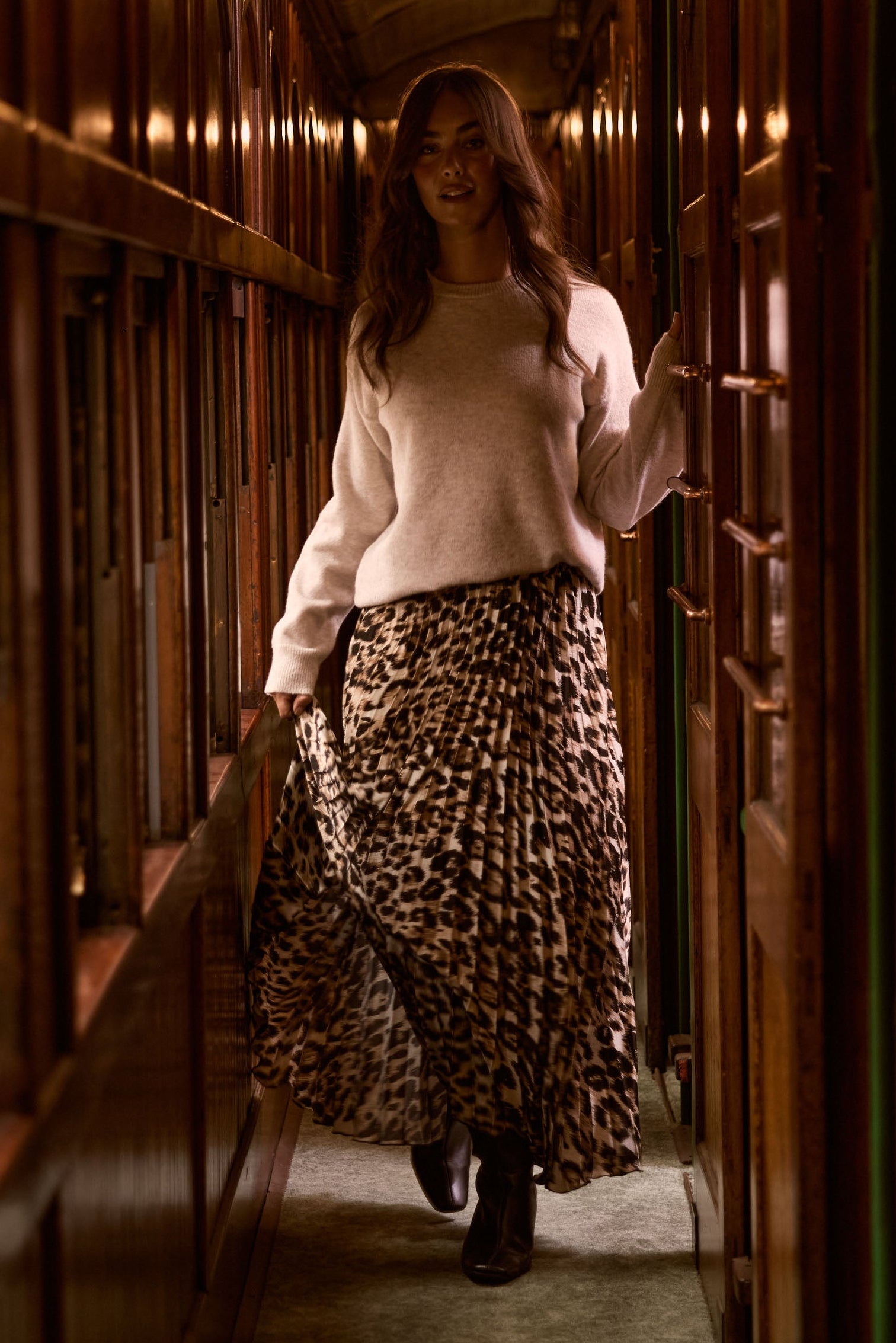 Model wearing Casey Knit - Oat, campaign view on white background