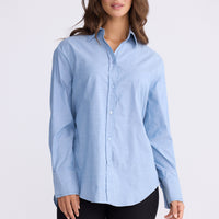 Model wearing Perry Shirt in blue with collar, front view on white background