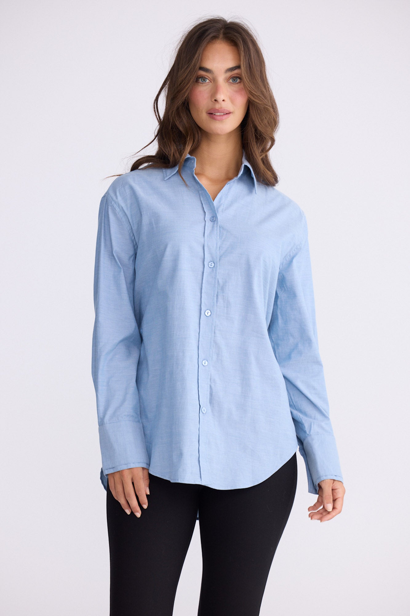 Model wearing Perry Shirt in blue with collar, front view on white background
