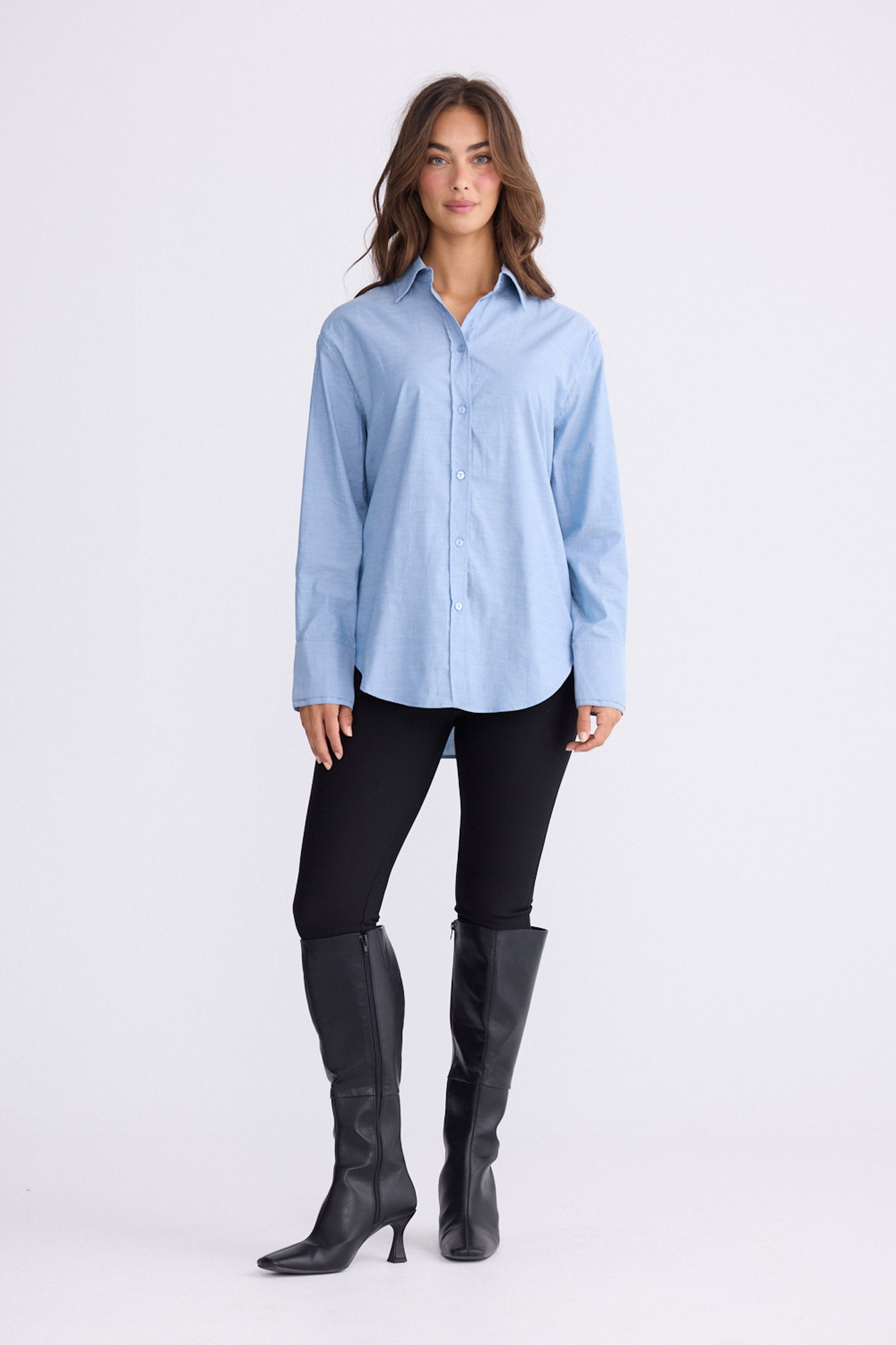 Model wearing Perry Shirt in blue with collar, front view on white background