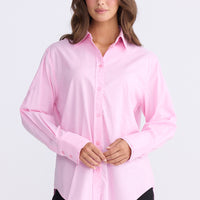 Model wearing Perry Shirt in pink with collar, front view on white background