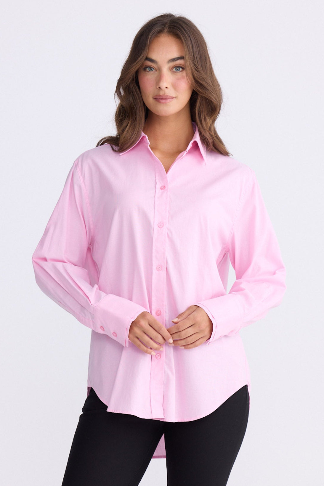 Model wearing Perry Shirt in pink with collar, front view on white background