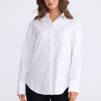 Model wearing Perry Shirt in white with collar, back view on white background