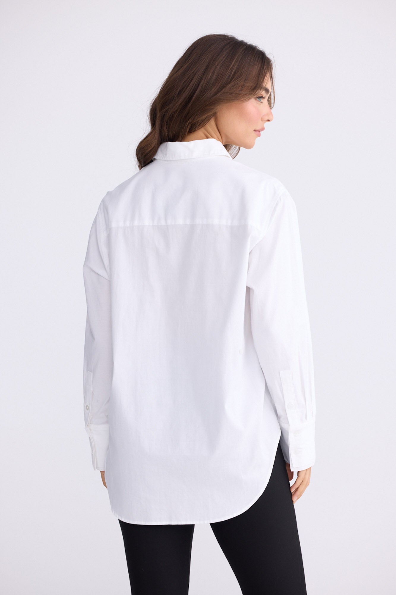 Model wearing Perry Shirt in white with collar, front view on white background