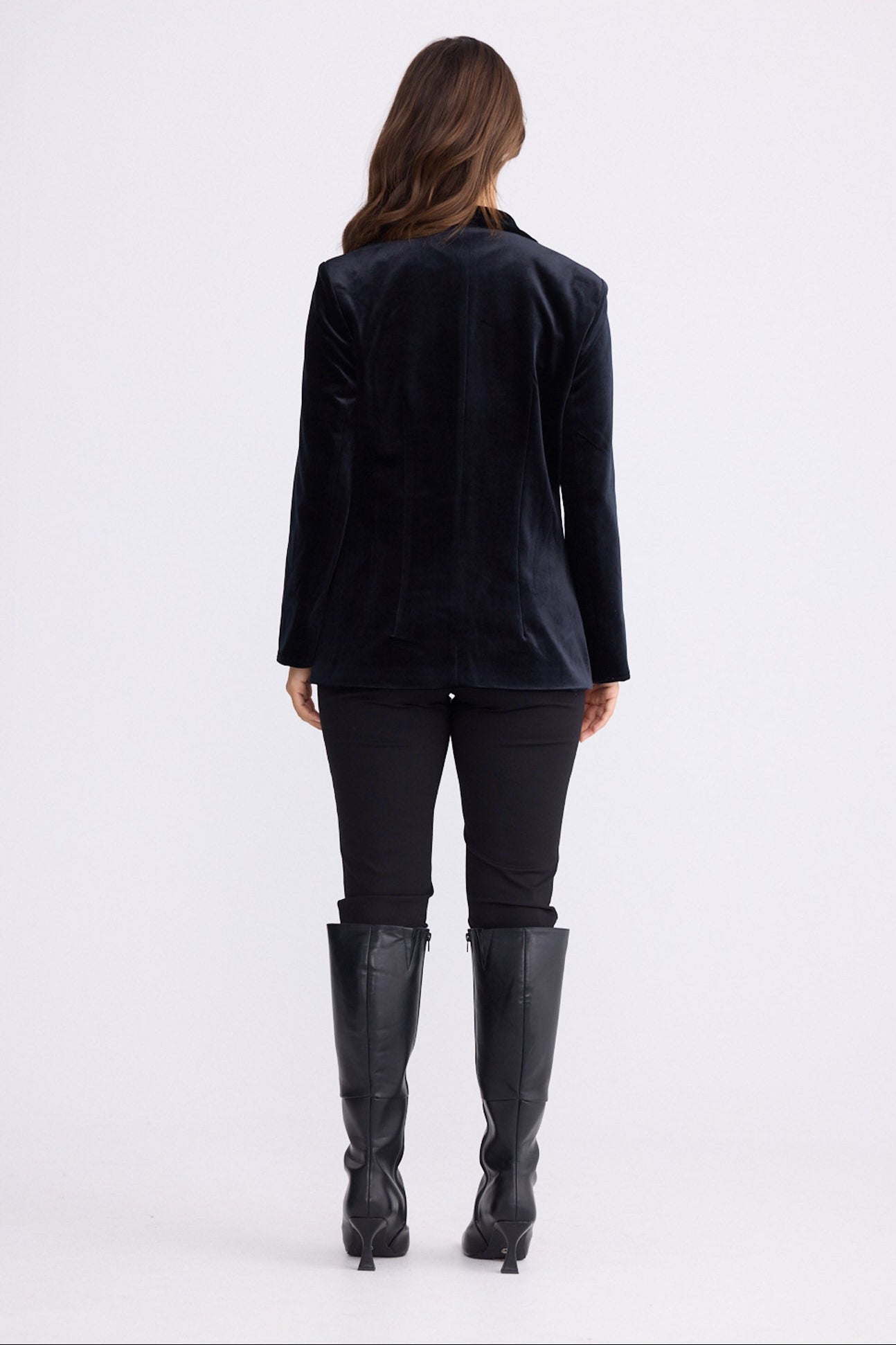 Model wearing Lillia Blazer in black with long sleeves, front view on white background