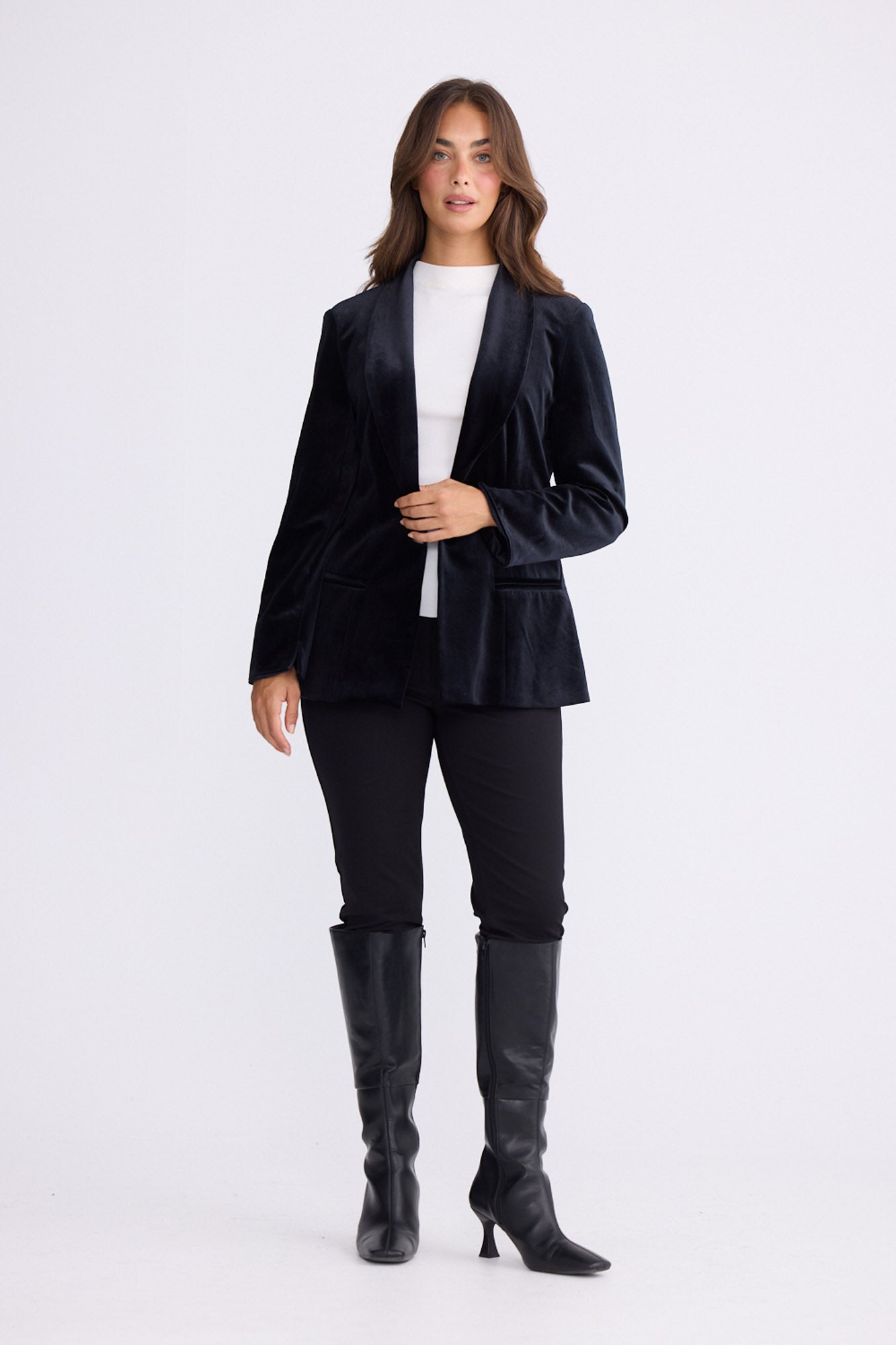 Model wearing Lillia Blazer in black with long sleeves, front view on white background
