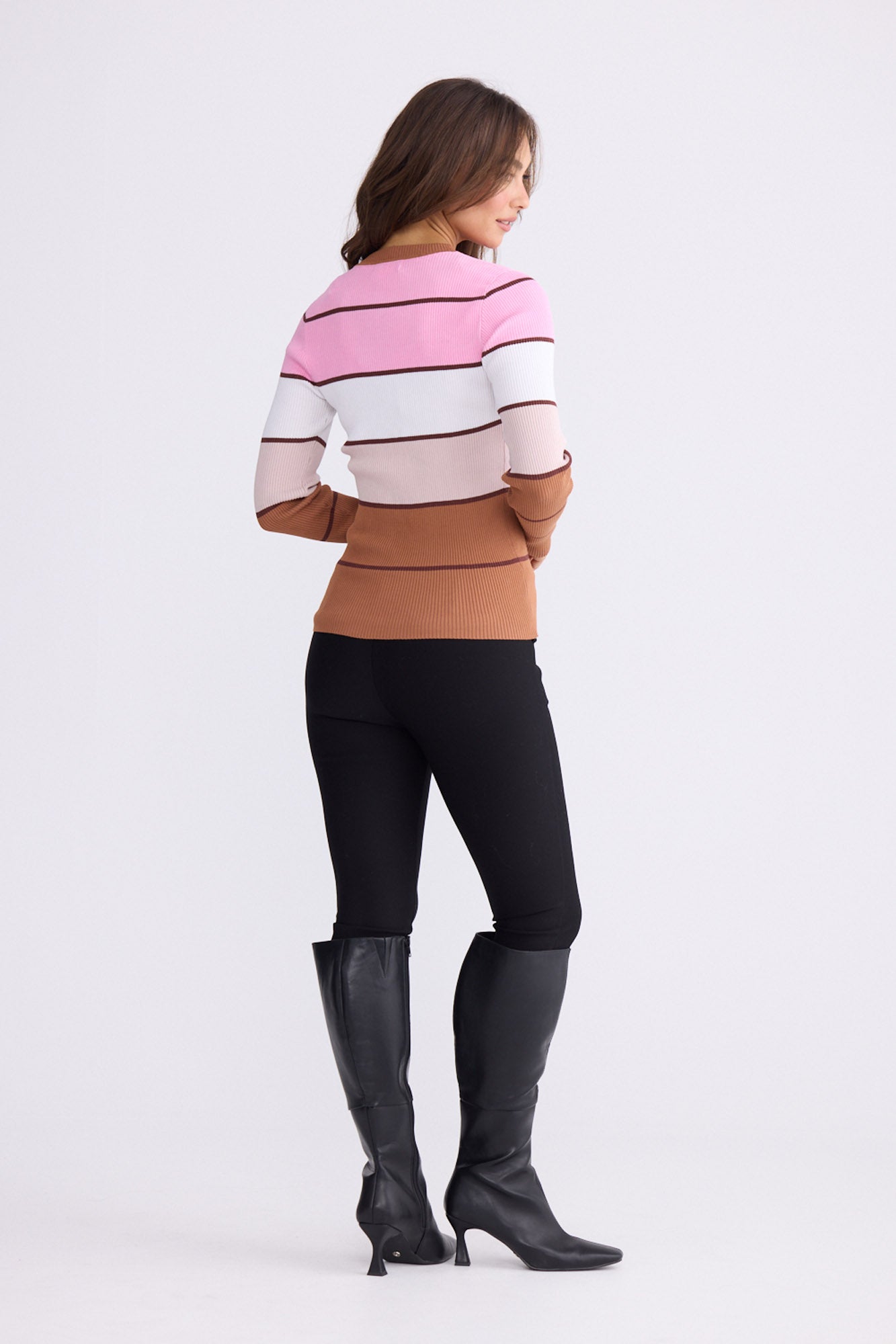 Model wearing Unley rose stripe rib knit top with fitted shape and long sleeves, back view on white background