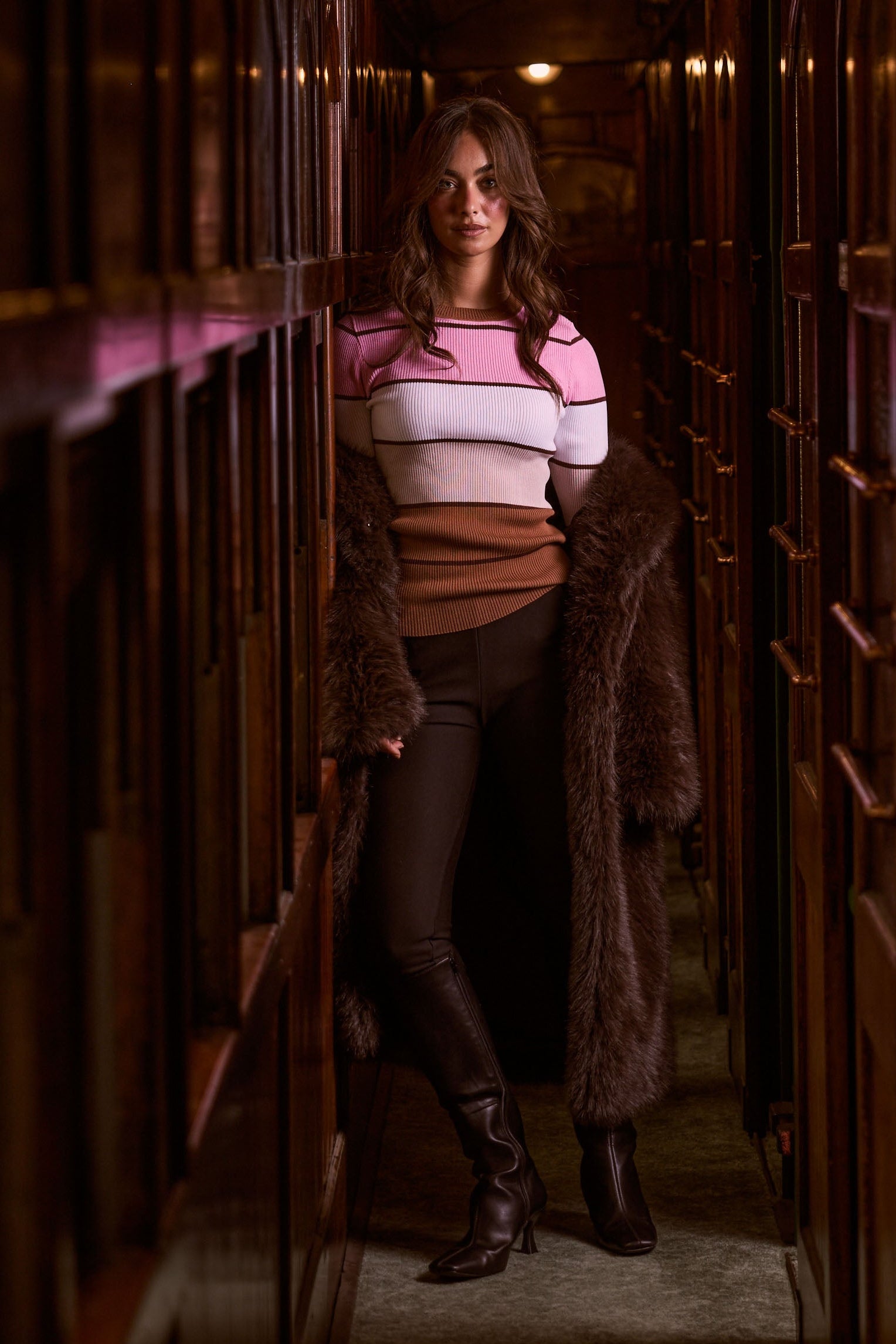 Model wearing Unley rose stripe rib knit top with fitted shape and long sleeves, campaign view on white background