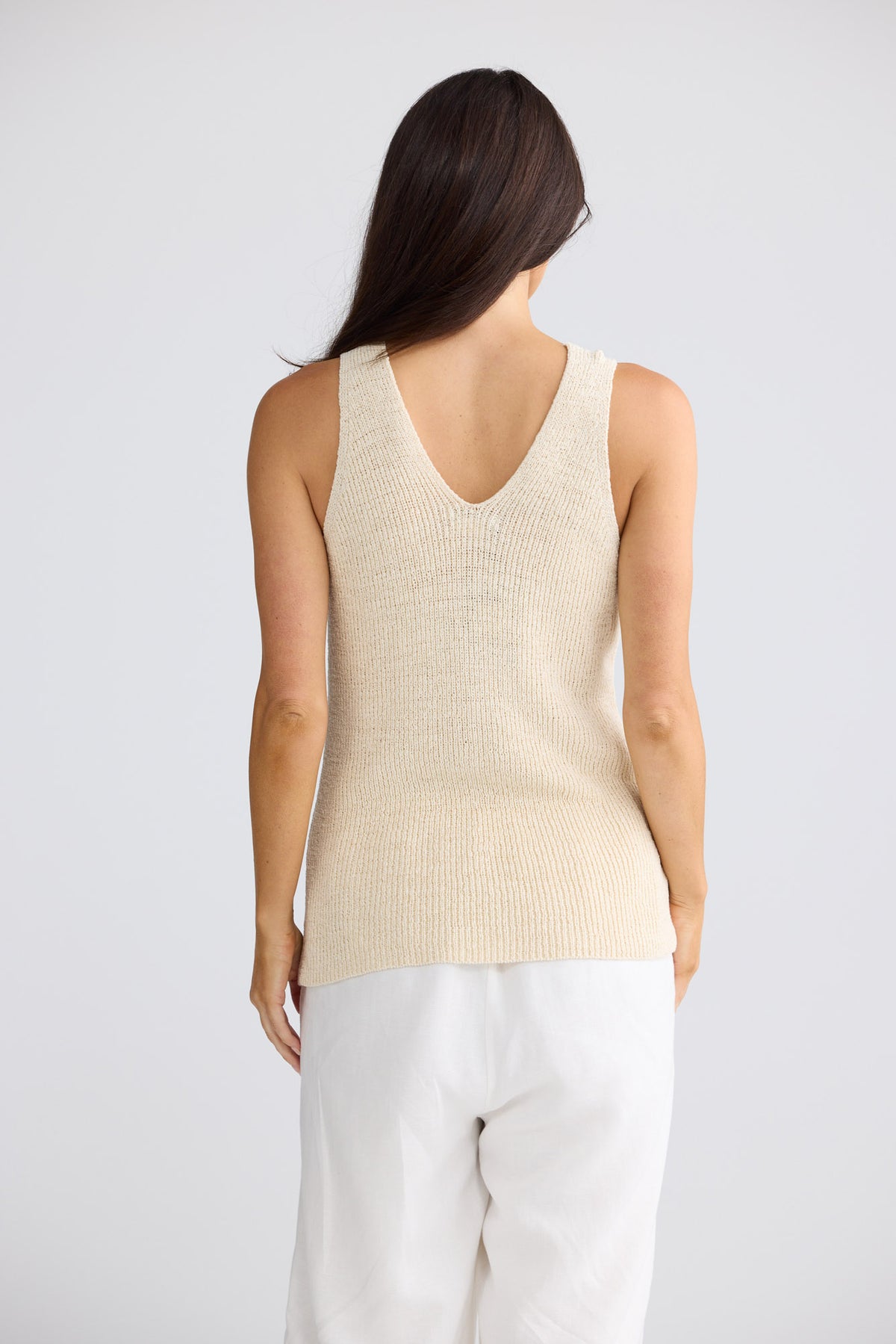 Model wearing Rosalie Knit Tank in natural beige by Brave + True, front view showing floral motif.