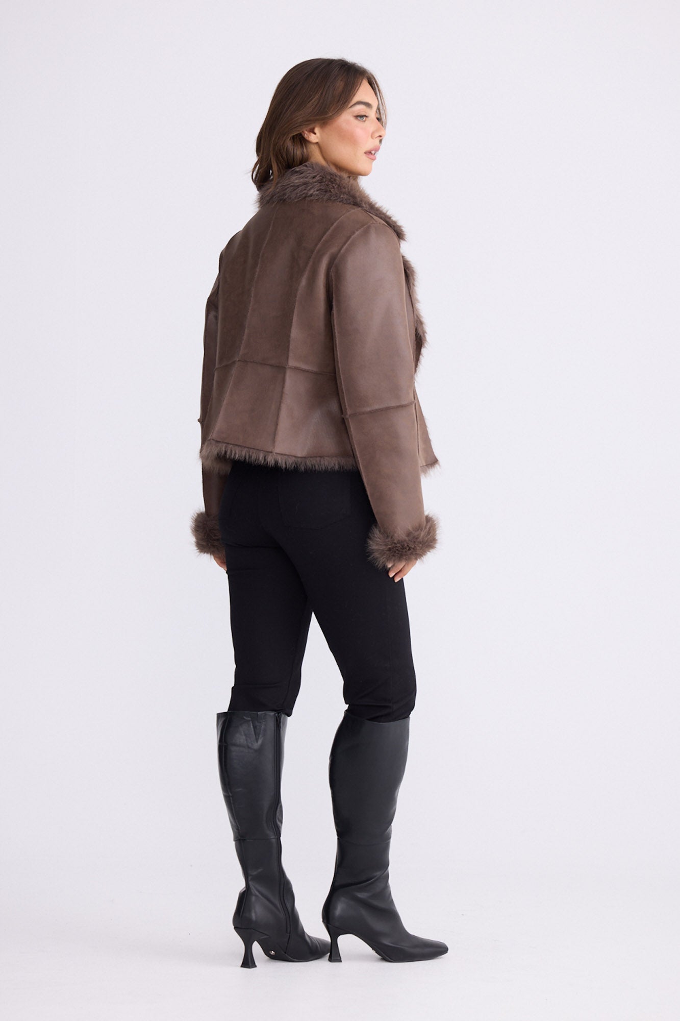 Model wearing Celia Fur Jacket - Chocolate, studio view on white background
