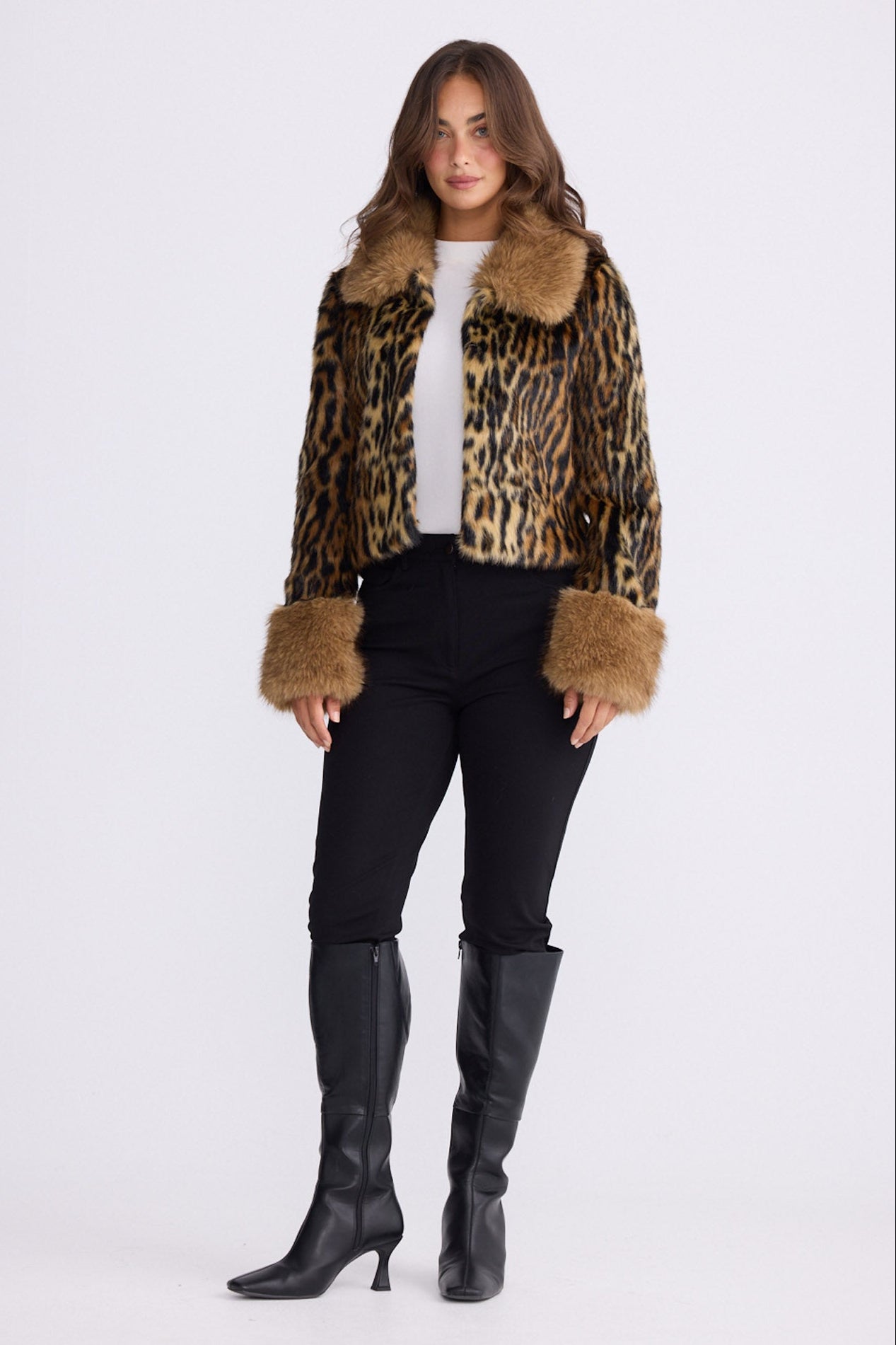 Model wearing Tatiana leopard faux fur jacket with plush collar and cuffs, front view on white background