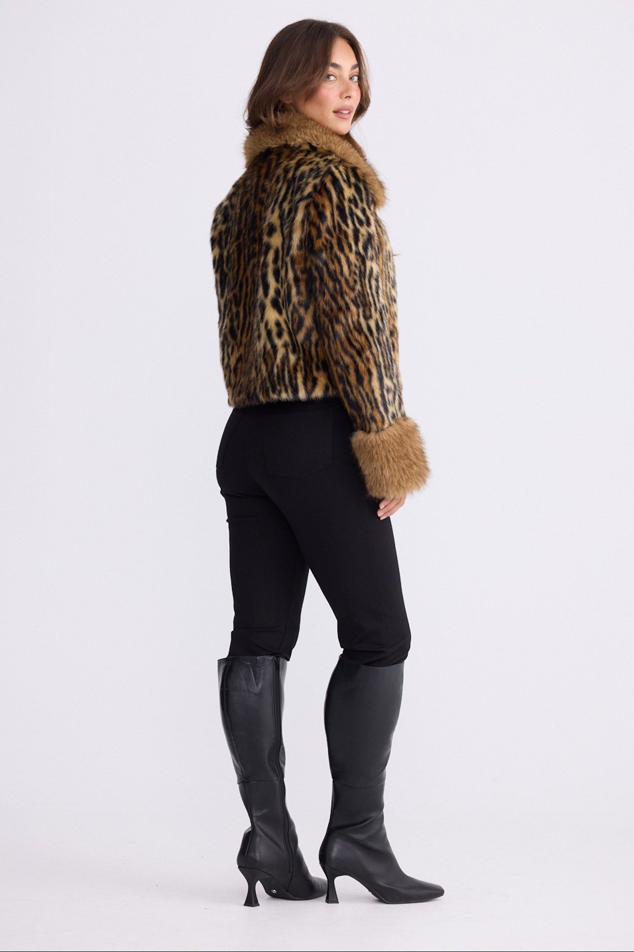 Model wearing Tatiana leopard faux fur jacket with plush collar and cuffs, alternate view on white background