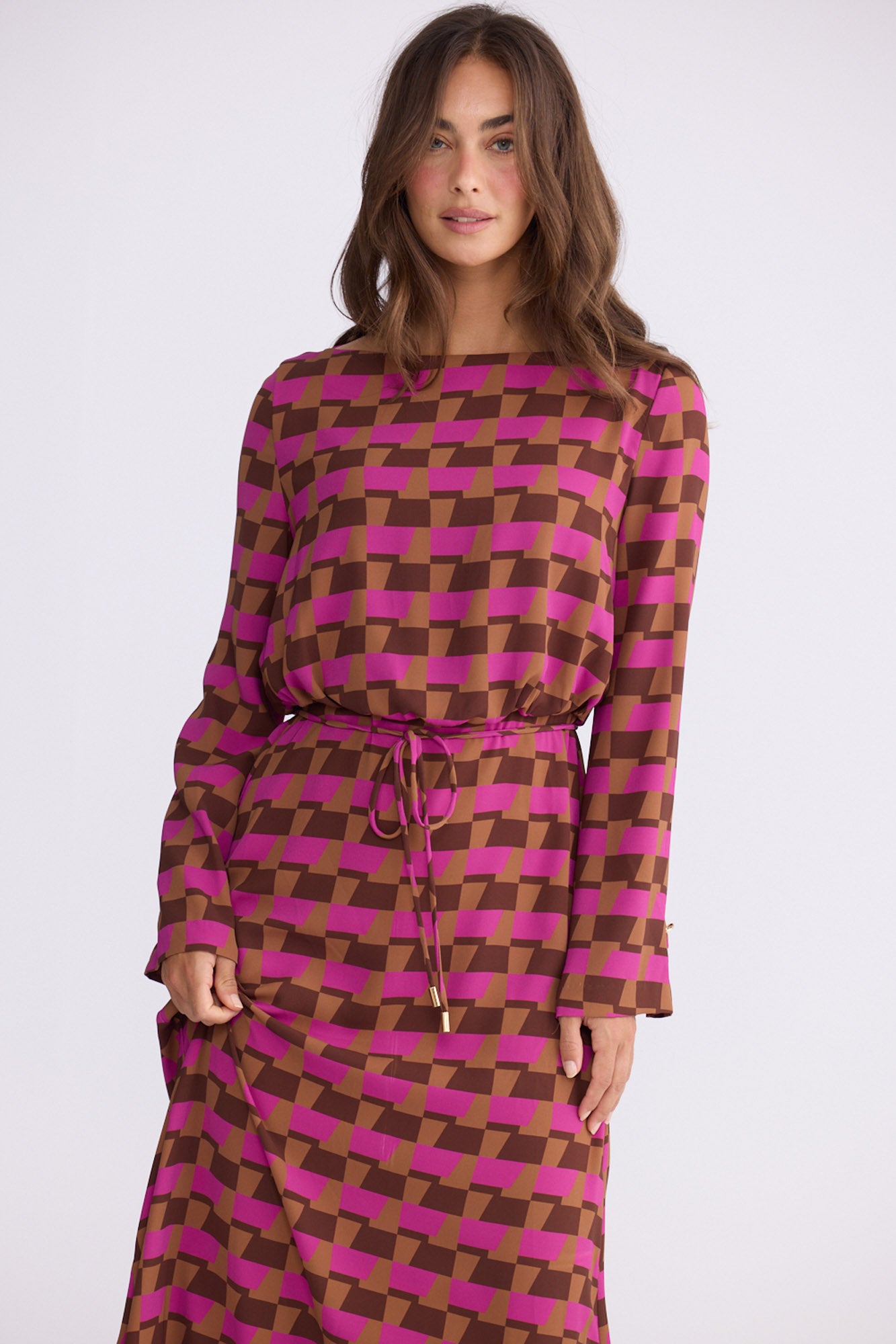 Model wearing Kensington Dress in geo prism with boat neckline and long sleeves, front view on white background