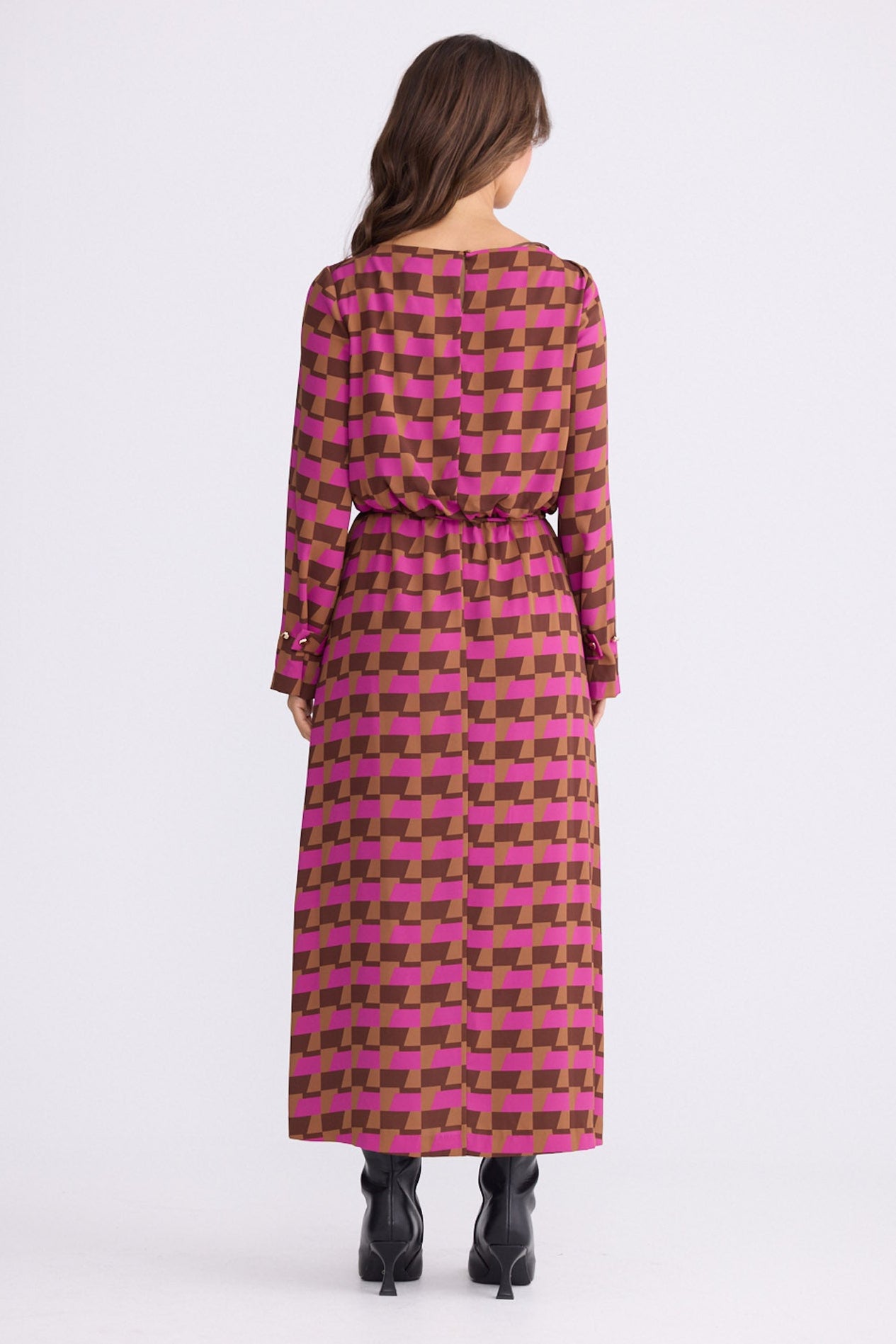 Model wearing Kensington Dress in geo prism with boat neckline and long sleeves, side view on white background