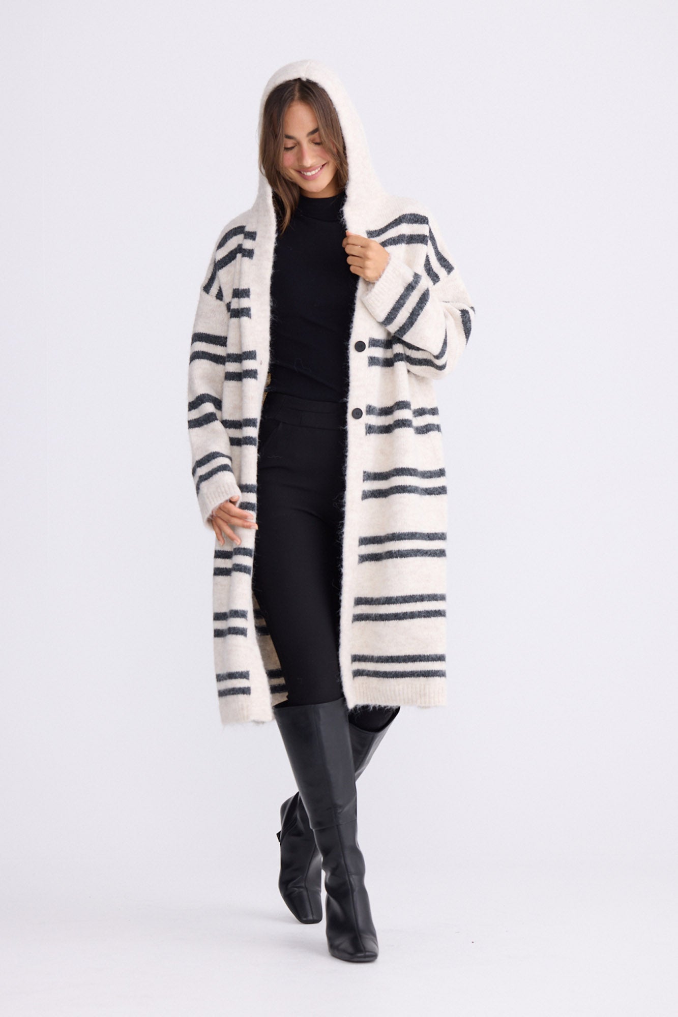 Model wearing Chelsea Knit Cardi - Natural W Grey Stripe, studio view on white background