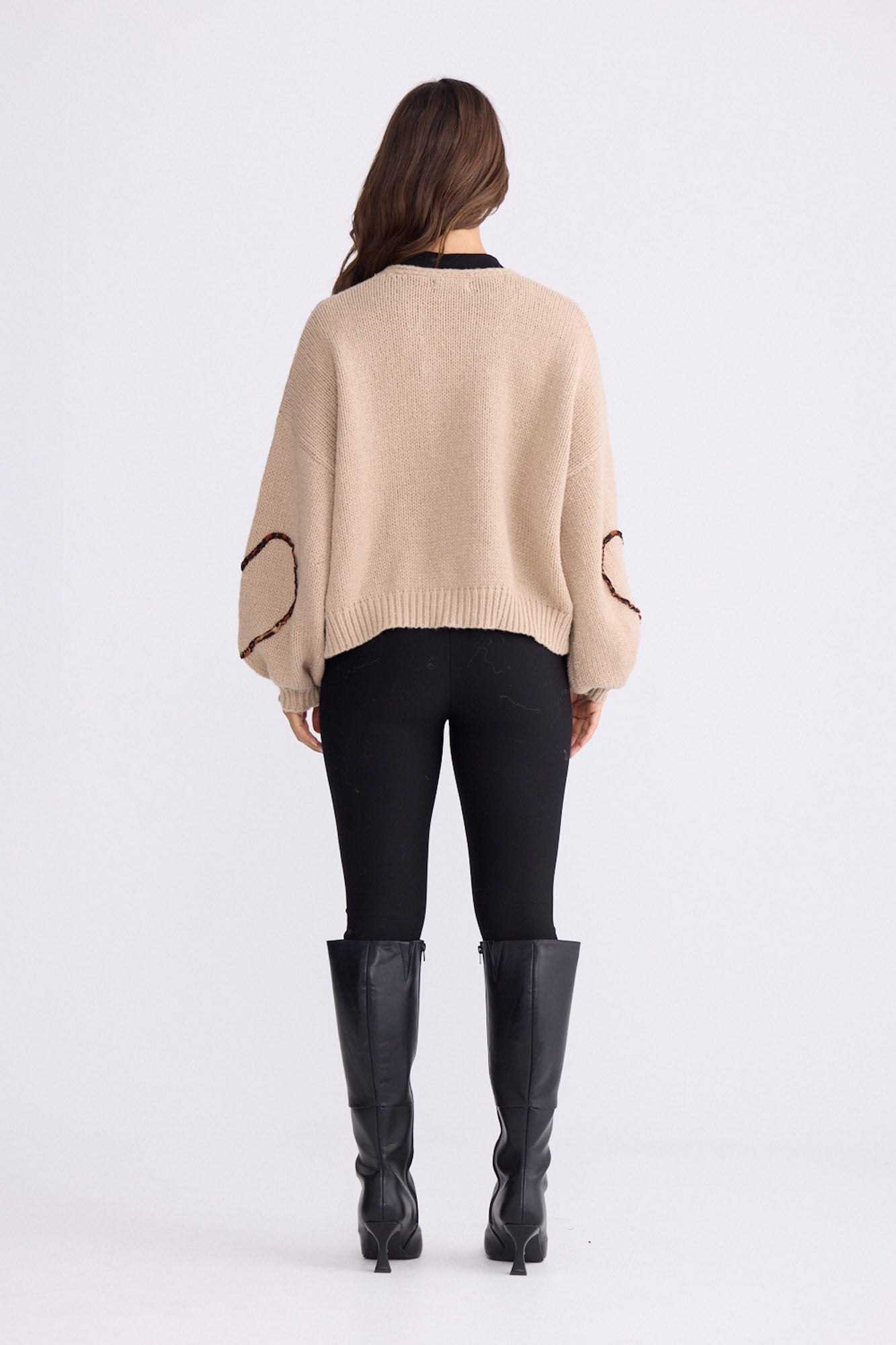Model wearing Angie Knit Cardi beige cardigan with V-neckline, button-front closure, alternate studio view on white background