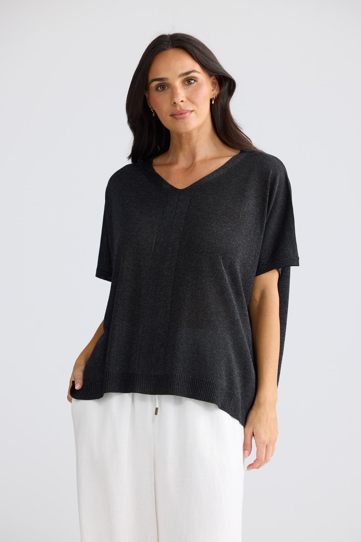 Model wearing Jessamy Top in black with silver detail by Brave + True, front view.