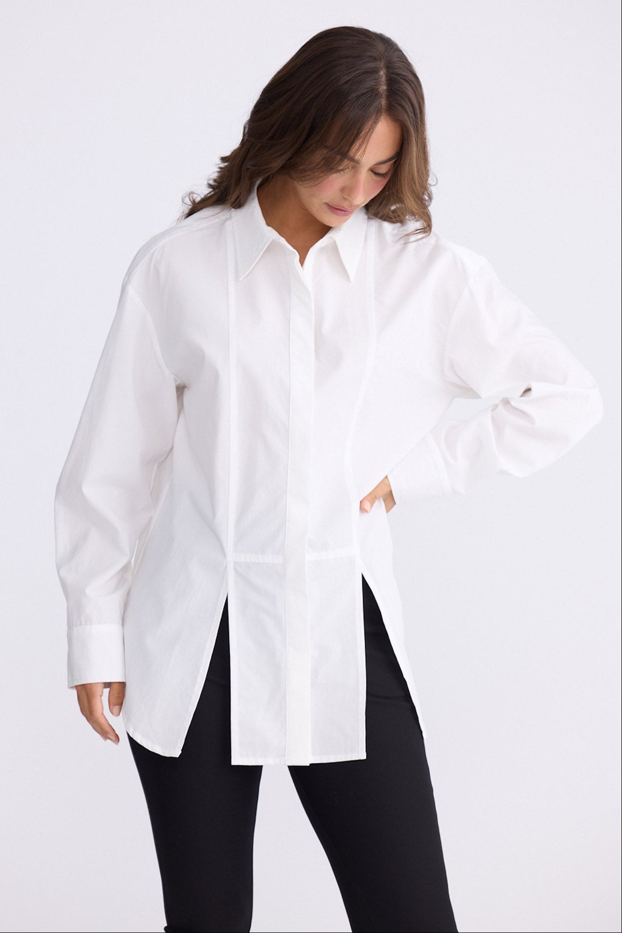 Model wearing Kara Shirt in white with collar, back view on white background