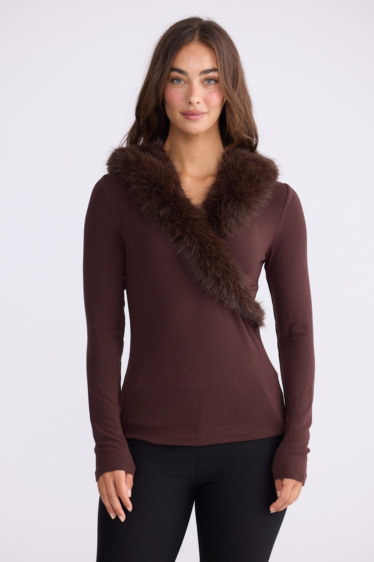 Model wearing Imelda Top in brown with V-neck and long sleeves, front view on white background