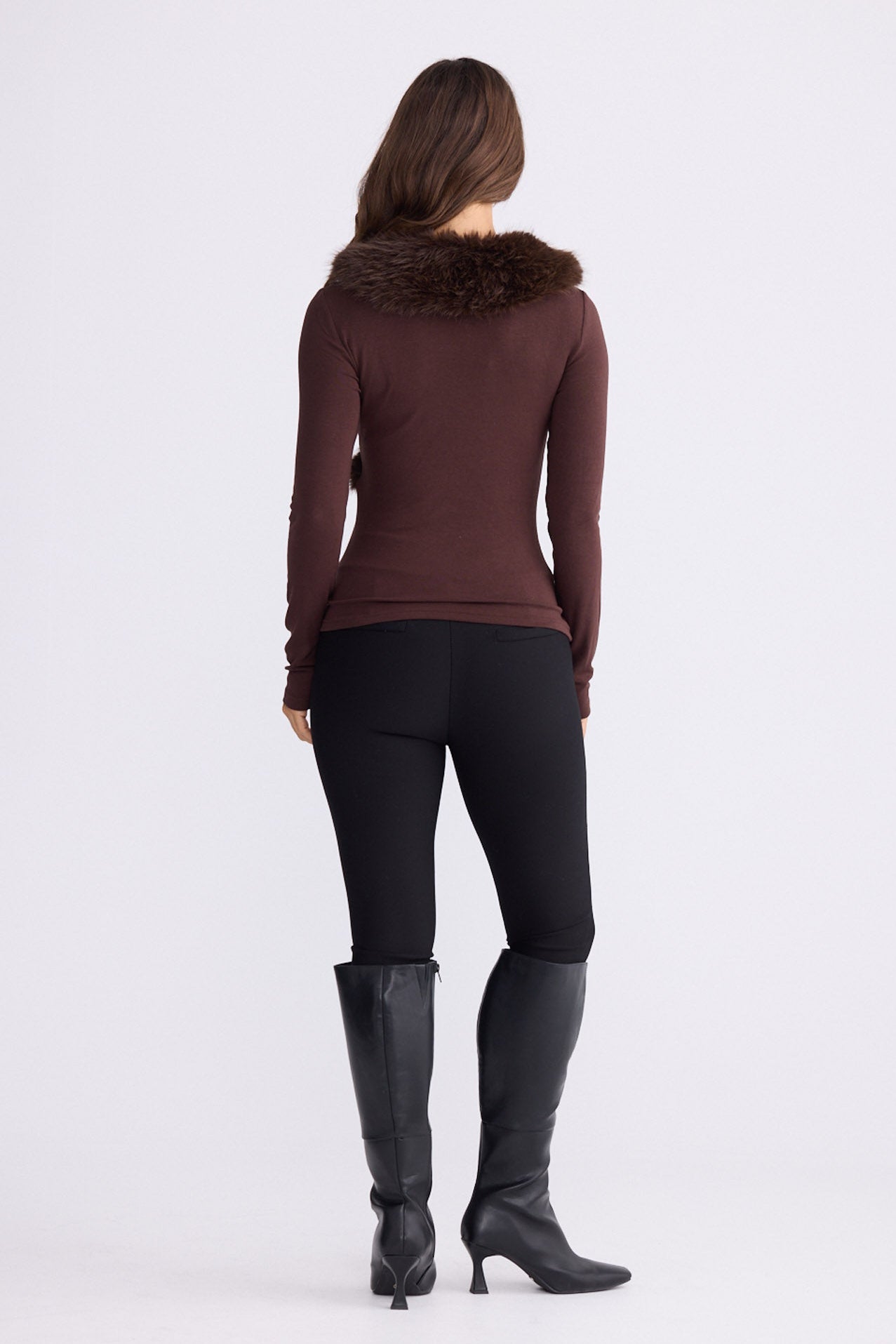 Model wearing Imelda Top in brown with V-neck and long sleeves, front view on white background