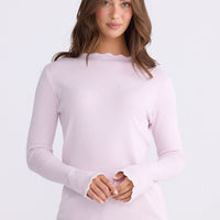 Model wearing Stacey blush knit top with scalloped contrast trim, alternate view on white background