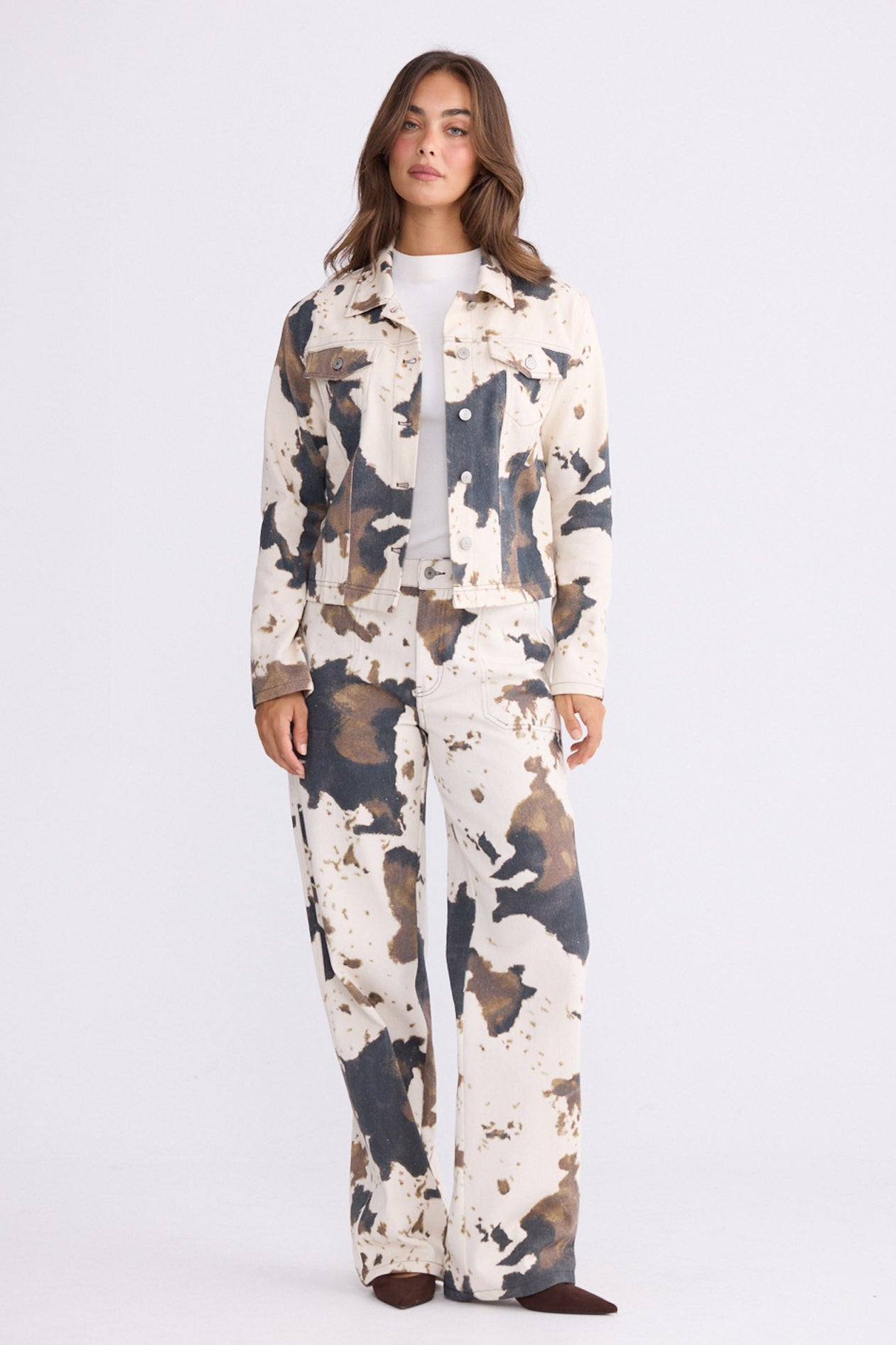 Model wearing Sidewalker Jacket in abstract cow with collar and long sleeves, front view on white background