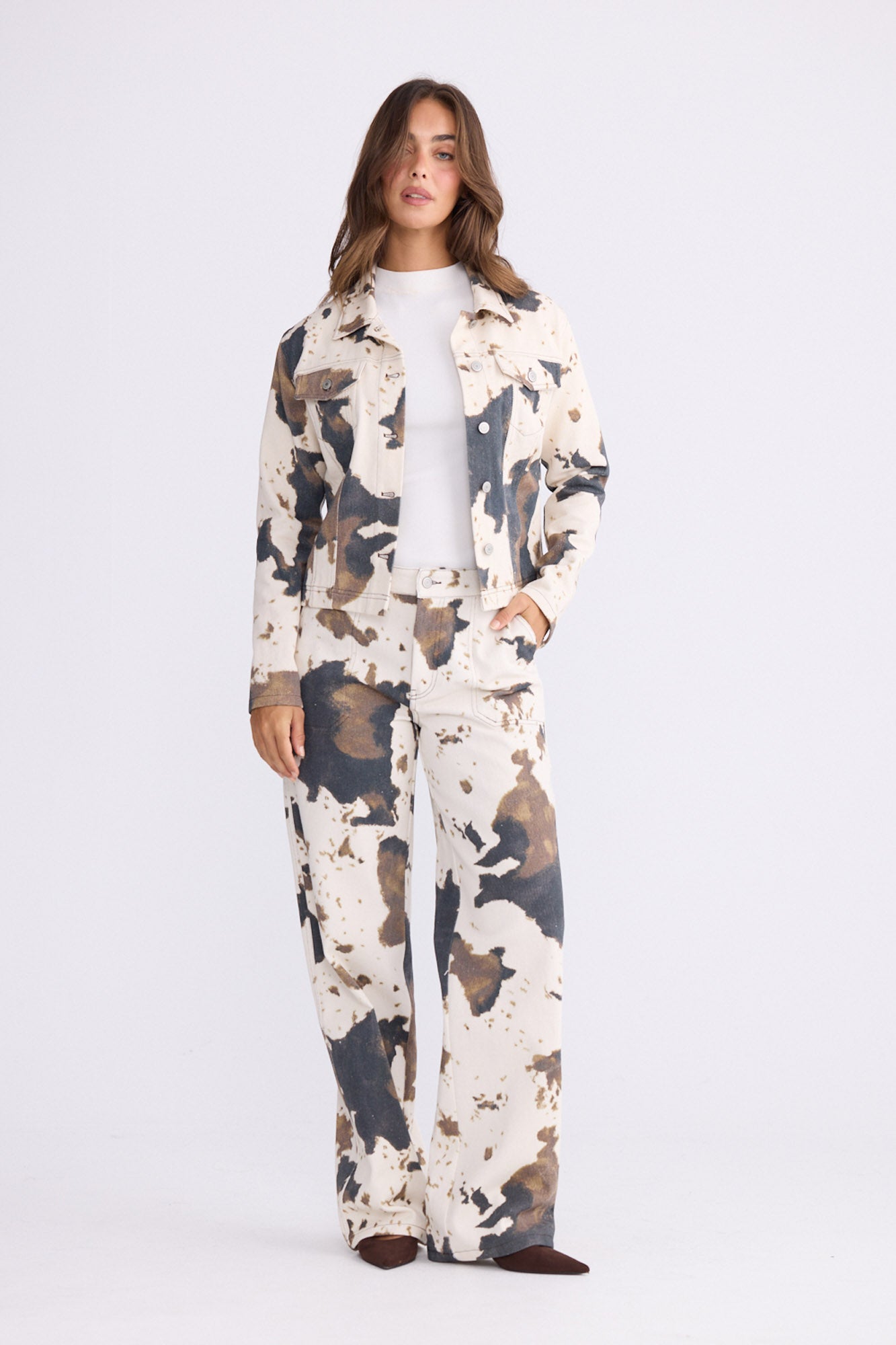 Woman wearing a camouflage-patterned outfit on white background