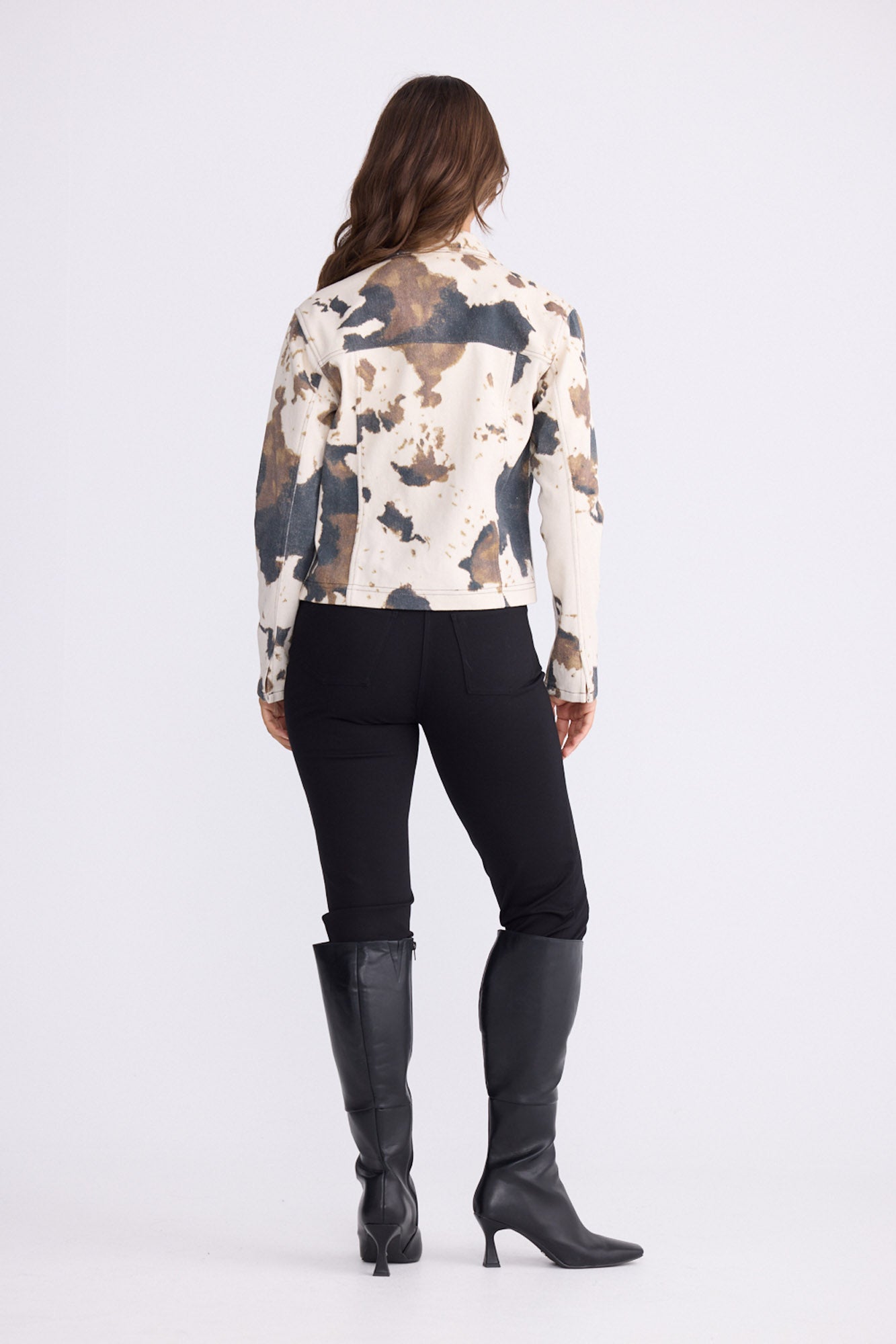 Model wearing Sidewalker Jacket in abstract cow with collar and long sleeves, front view on white background