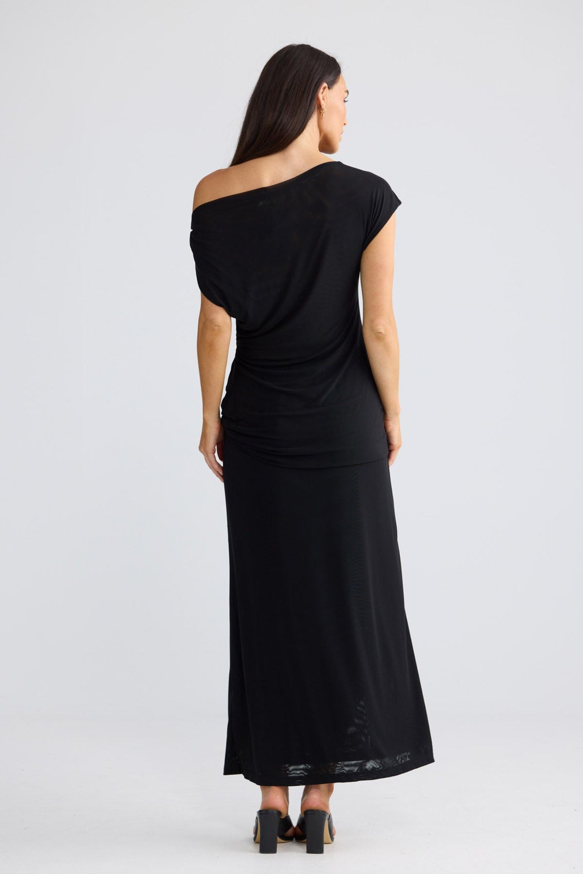 Model wearing Harriet Top in black by Brave + True, front view showing asymmetrical neckline.