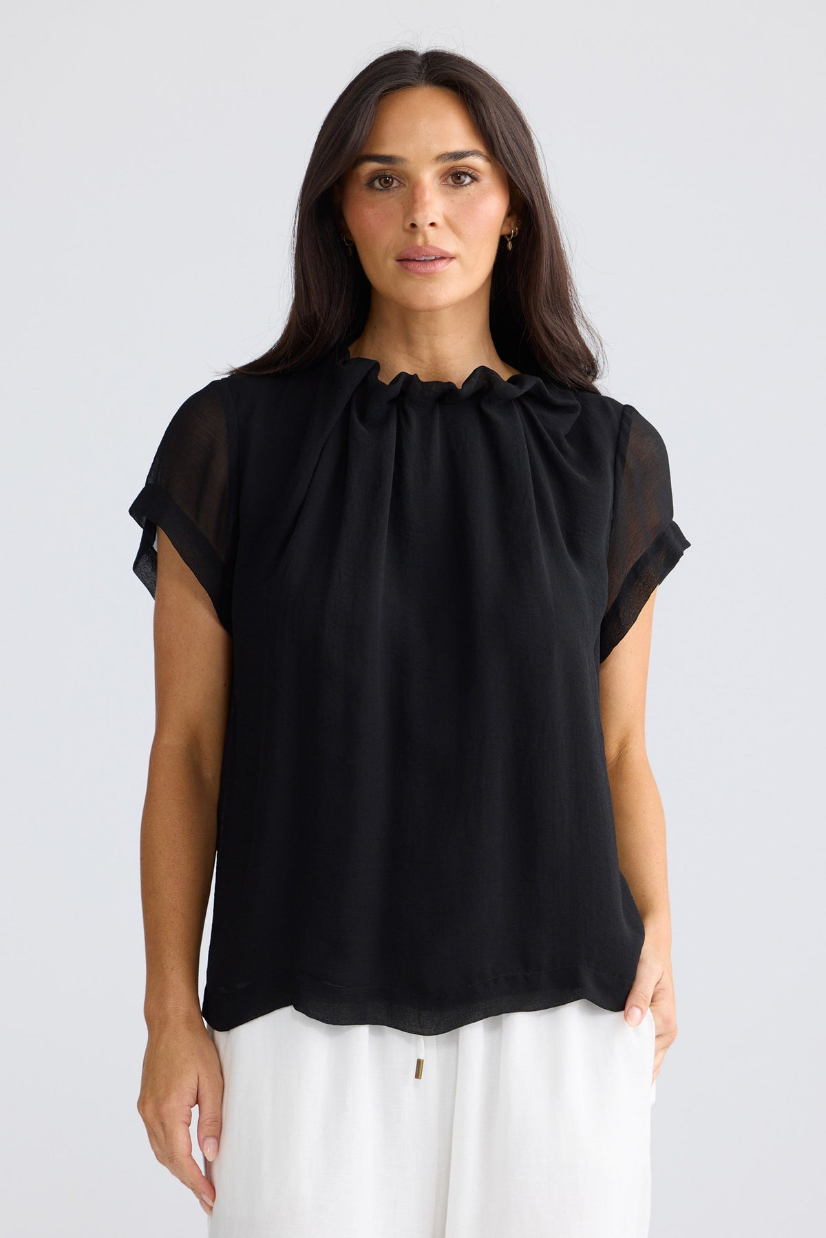 Model wearing Carina Blouse in black by Brave + True, front view showing gathered neckline.
